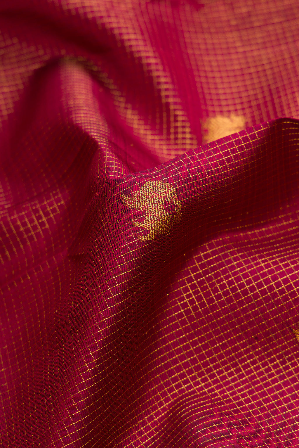 Close up of Maroon Kanjivaram Silk Saree with Zari Butta on the body and Zari Border.  displaying folds