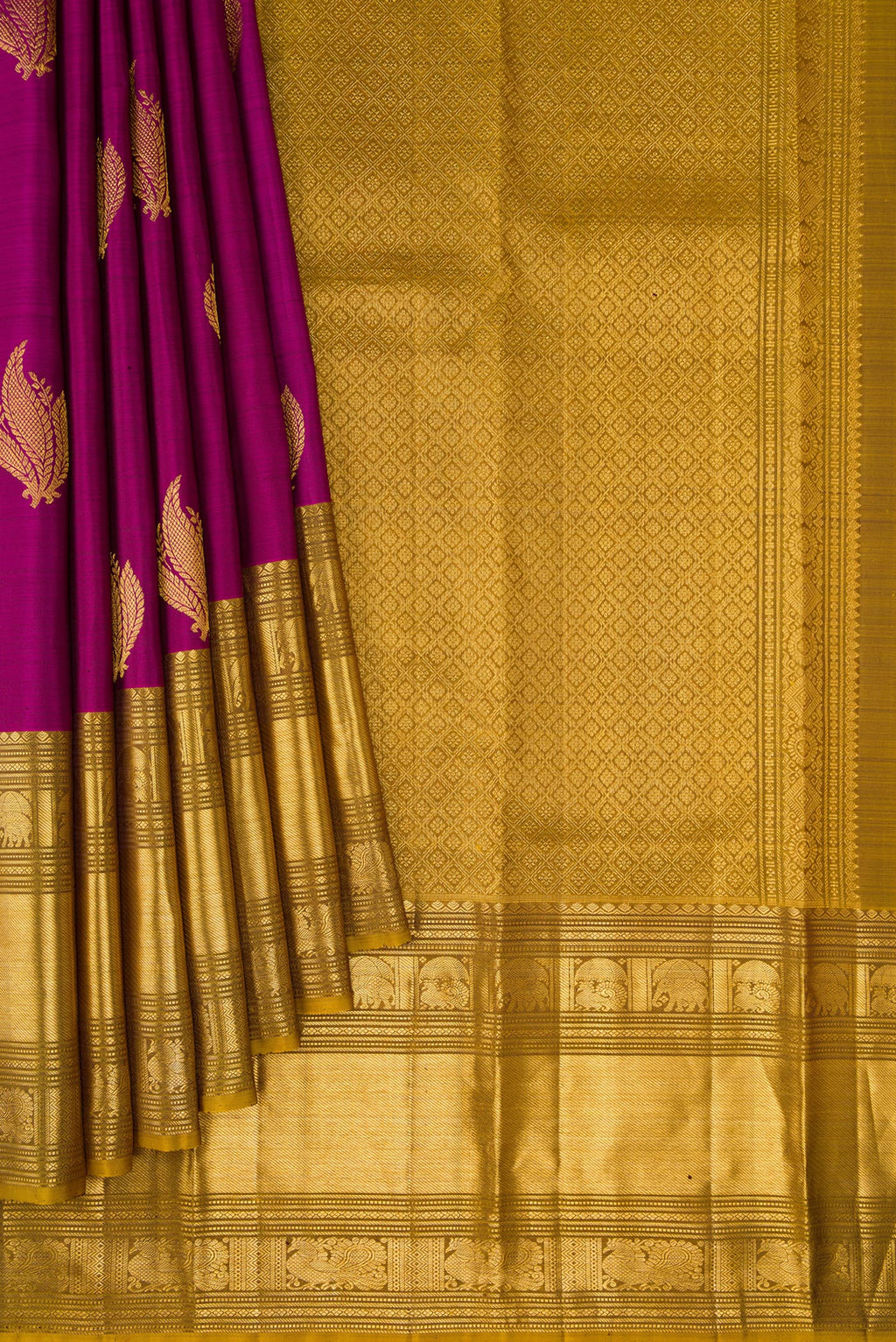 Pleats and pallu of Magenta Kanchipuram Silk Saree with Zari Butta on the body and Zari Border. 
