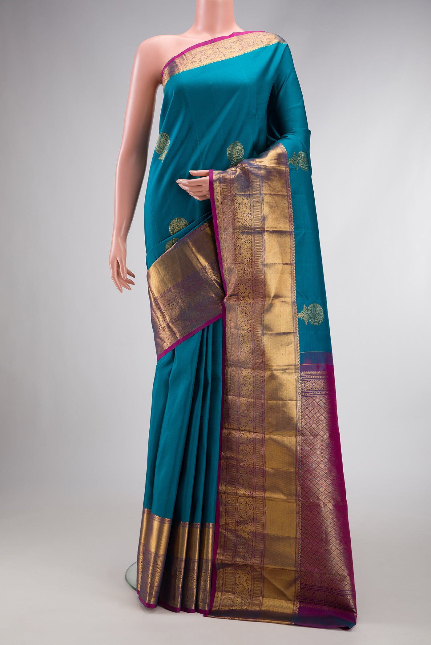 Maya Blue Dual Tone Kanchipuram Silk Saree with Zari Butta on the body and Zari Border.  displayed on a mannequin