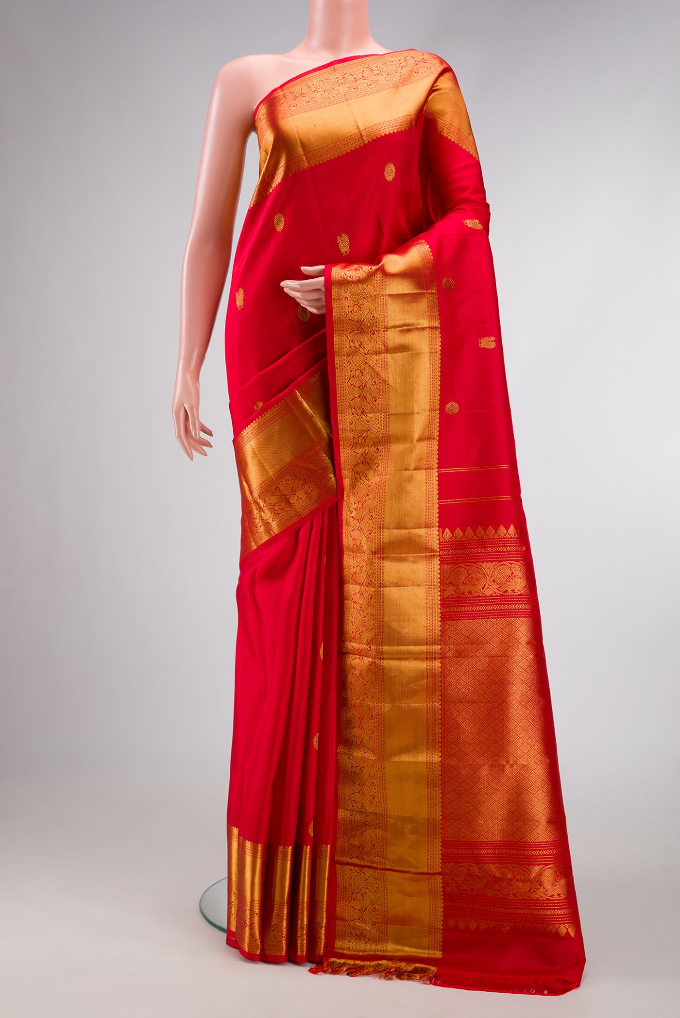 Red Dual Tone Kanchipuram Silk Saree with Zari Butta on the body and Zari Border.  displayed on a mannequin