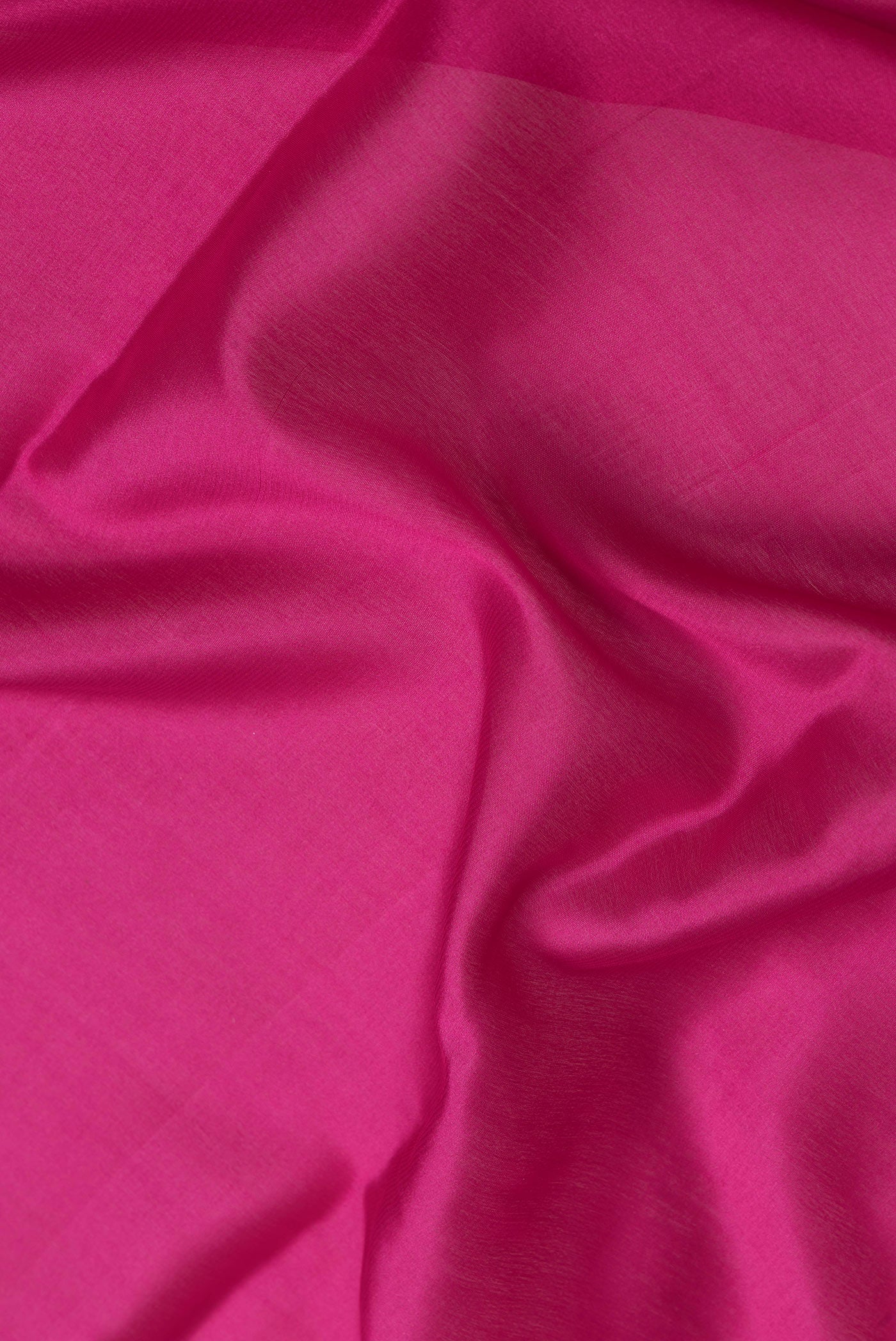Close up of Magenta Dual Tone Mysore Silk Saree with Plain Body and Zari Border.  displaying folds
