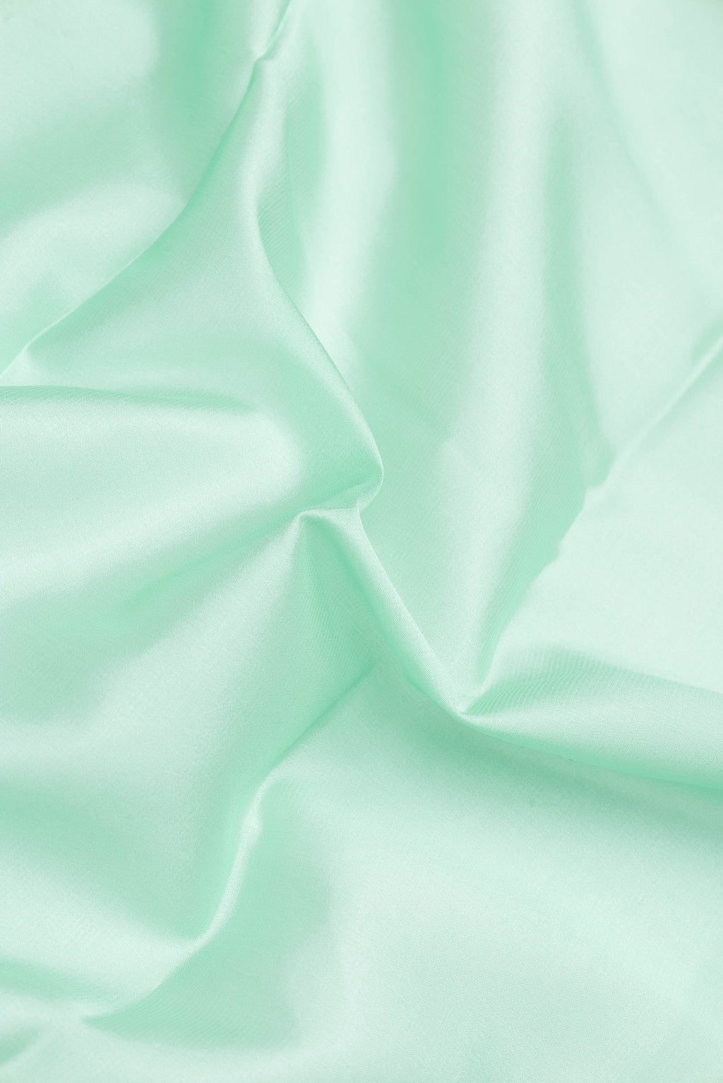 Close up of Pista Green Dual Tone Mysore Silk Saree with Plain Body and Zari Border.  displaying folds