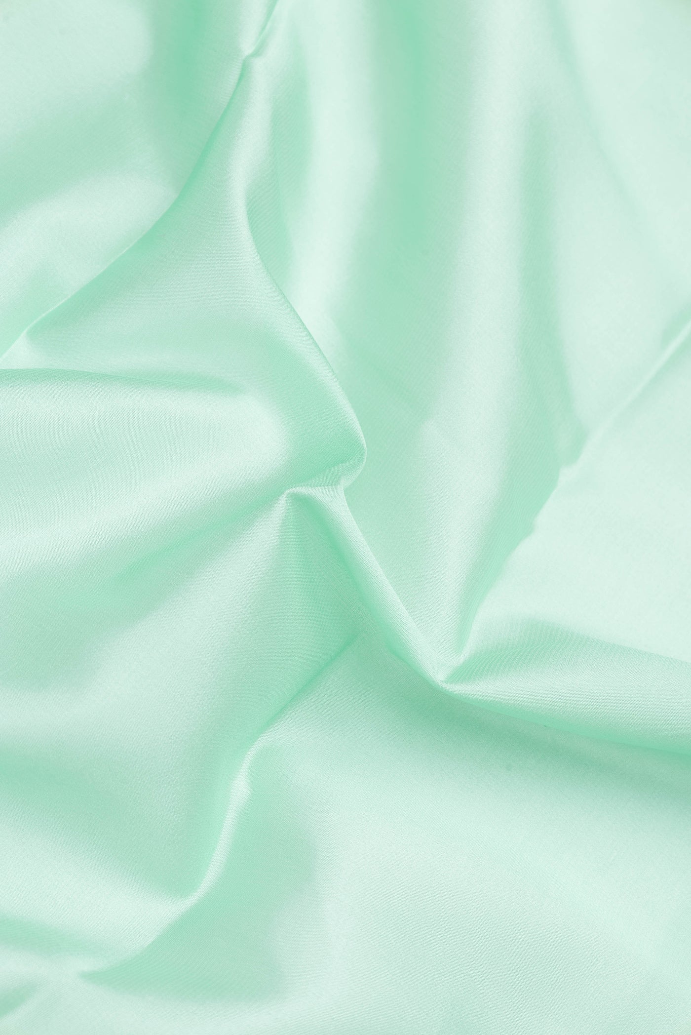 Close up of Pista Green Dual Tone Mysore Silk Saree with Plain Body and Zari Border.  displaying folds