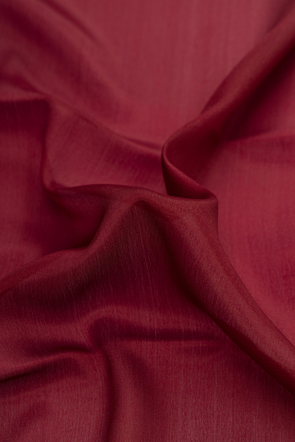 Close up of Brown Dual Tone Mysore Crepe Saree with Plain Body and Zari Border.  displaying folds
