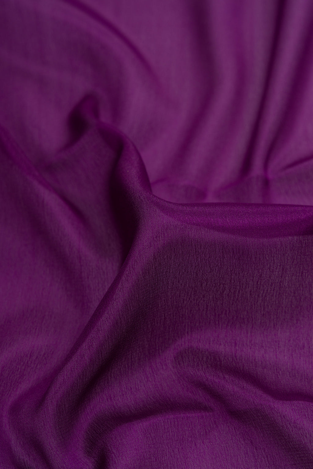 Close up of Violet Dual Tone Mysore Crepe Saree with Plain Body and Zari Border.  displaying folds