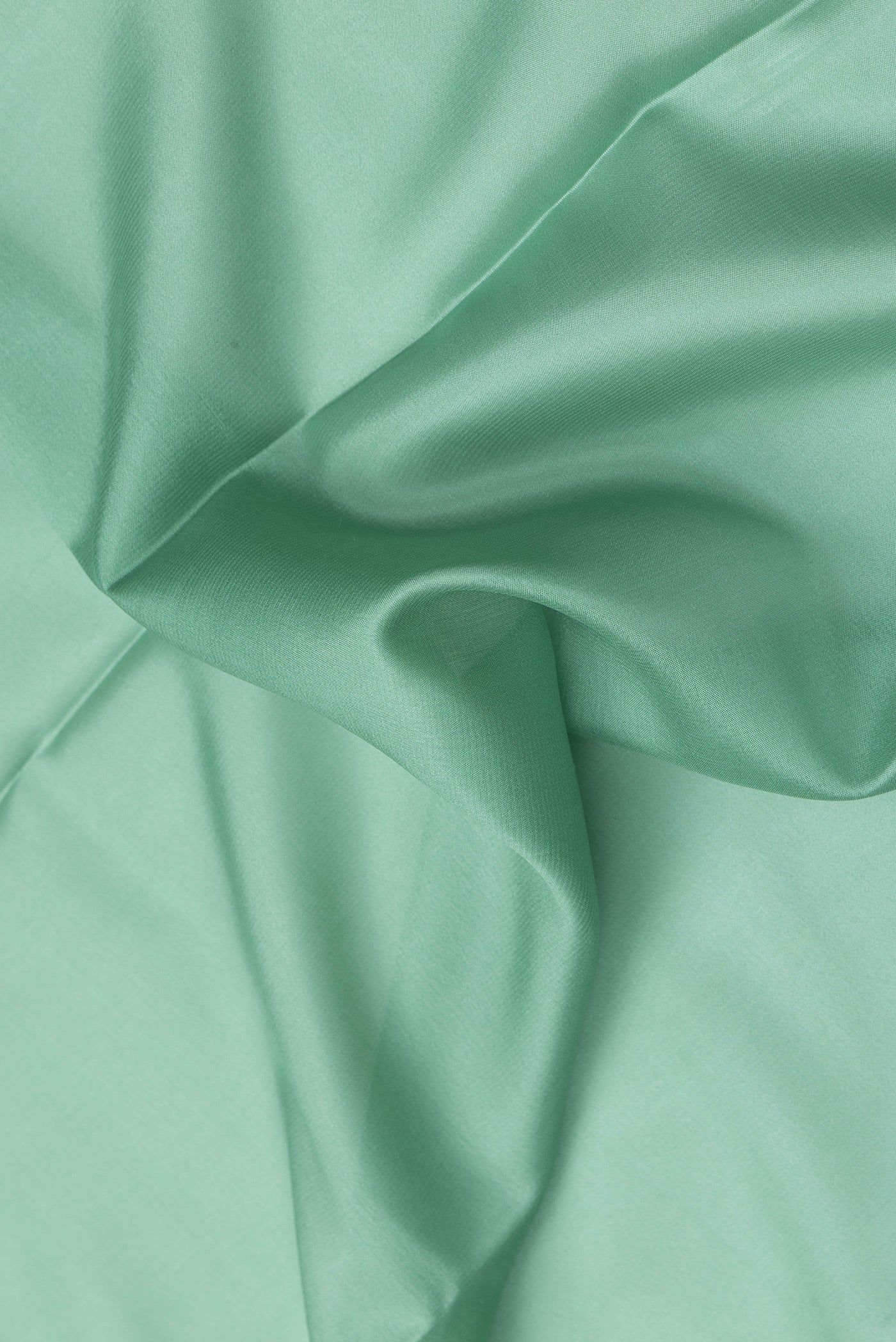 Close up of Sea Green Dual Tone Mysore Silk Saree with Plain Body and Zari Border.  displaying folds