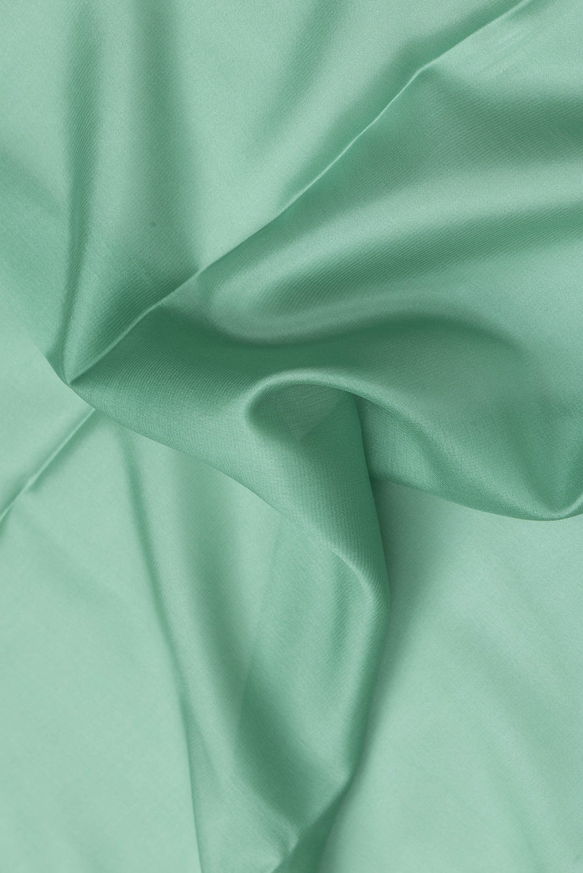 Close up of Sea Green Dual Tone Mysore Silk Saree with Plain Body and Zari Border.  displaying folds
