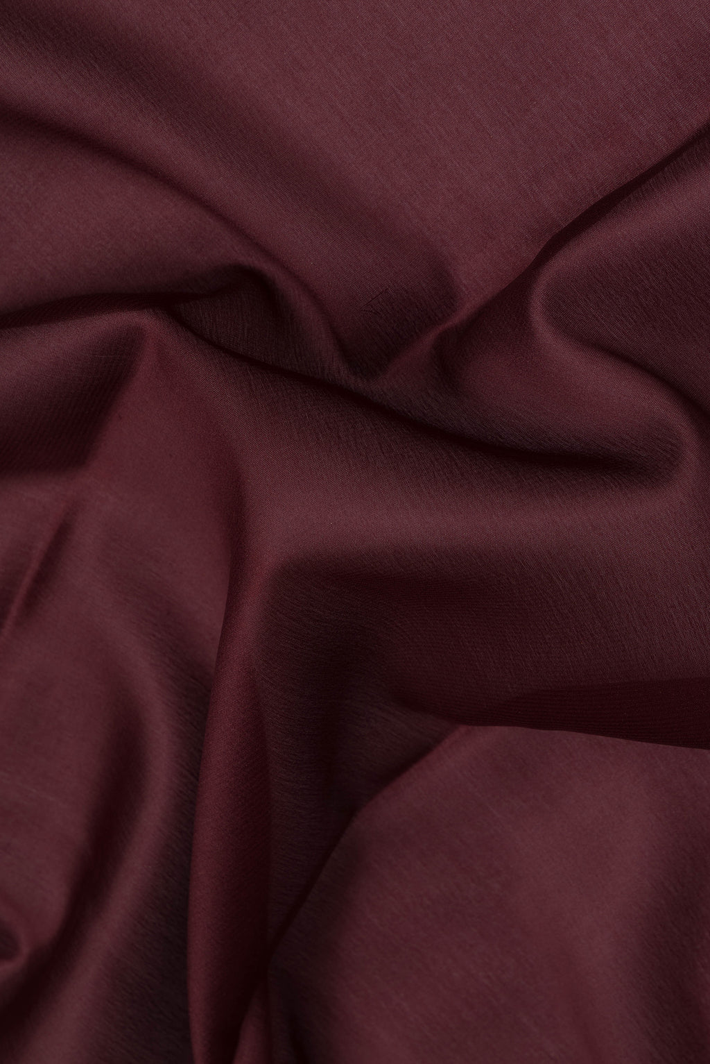 Close up of Coffee Brown Mysore Crepe Saree with Plain Body and Zari Border.  displaying folds