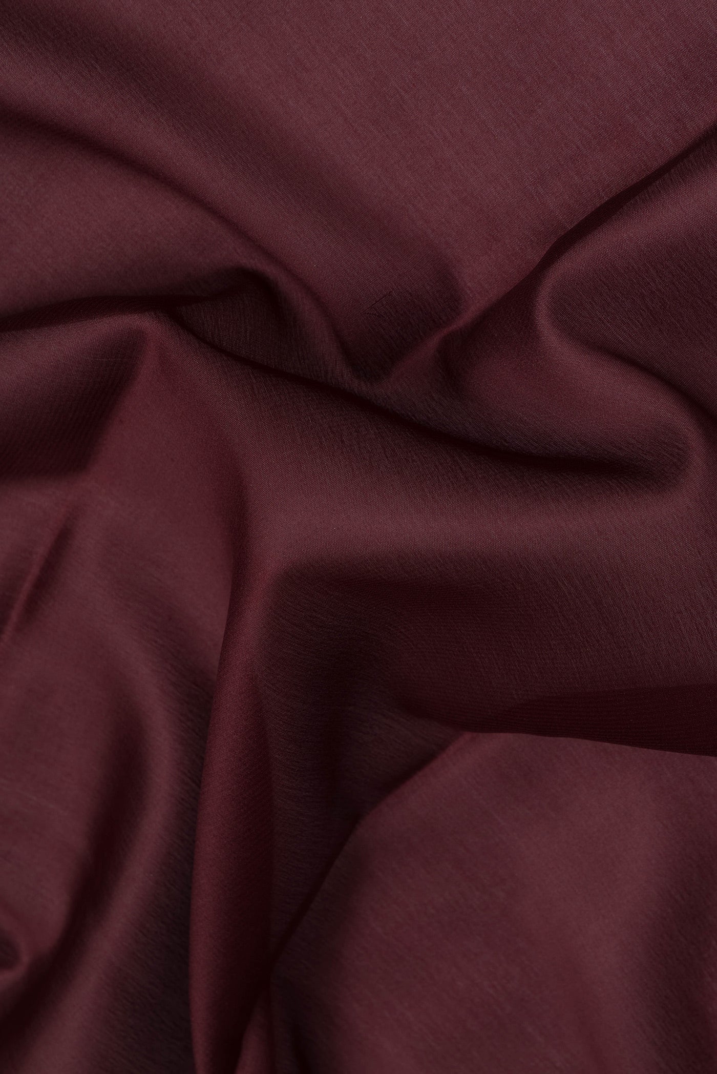 Close up of Coffee Brown Mysore Crepe Saree with Plain Body and Zari Border.  displaying folds