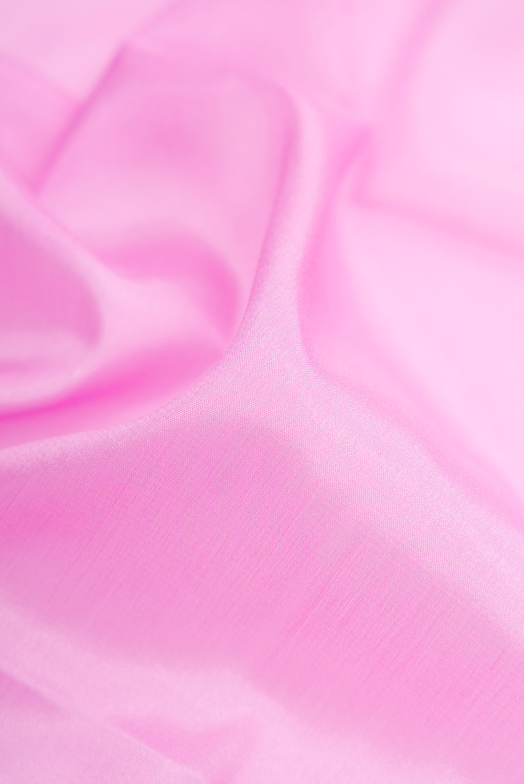 Close up of Pink Mysore Crepe Saree with Plain Body and Zari Border.  displaying folds