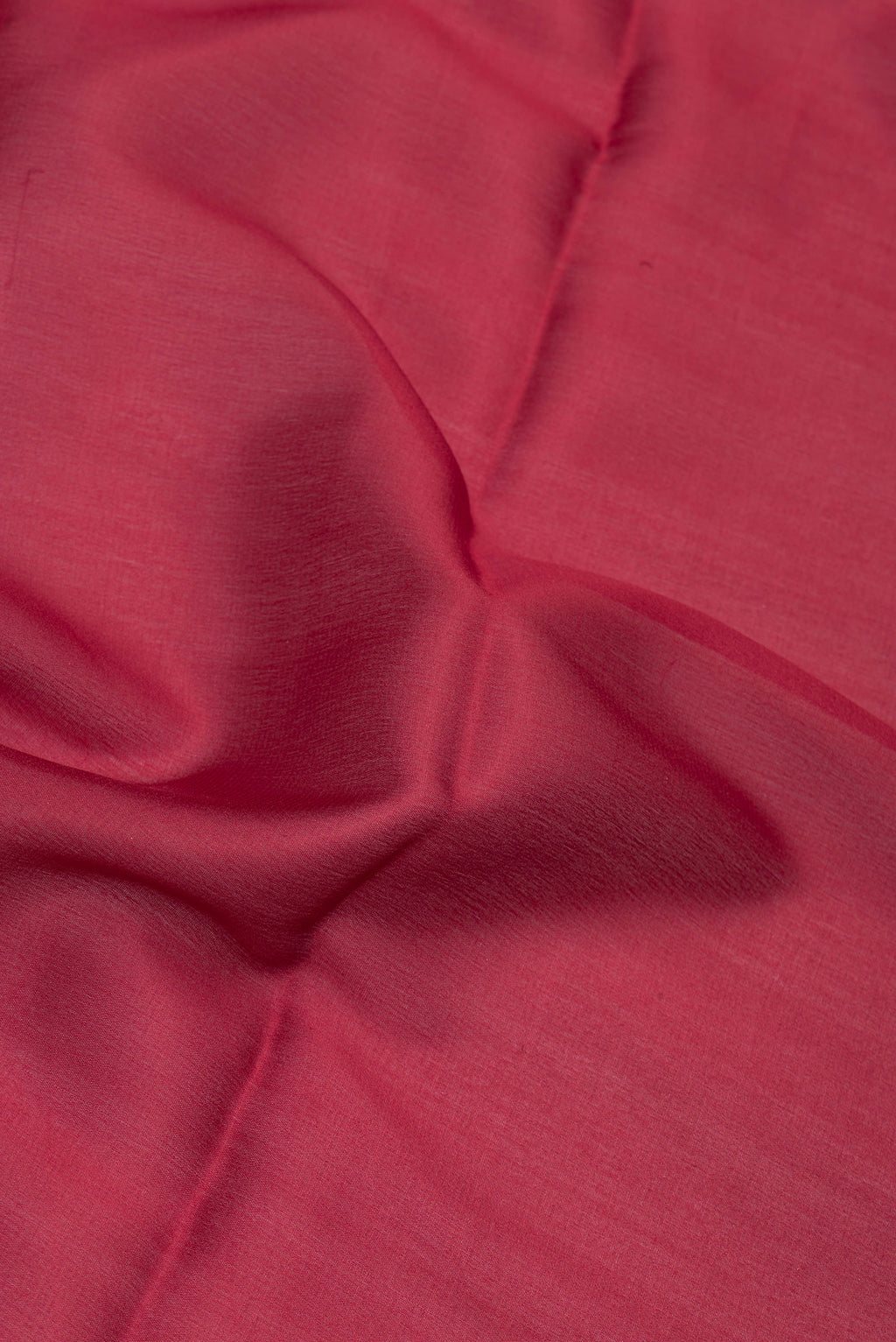Close up of Maroon Mysore Crepe Saree with Plain Body and Zari Border.  displaying folds