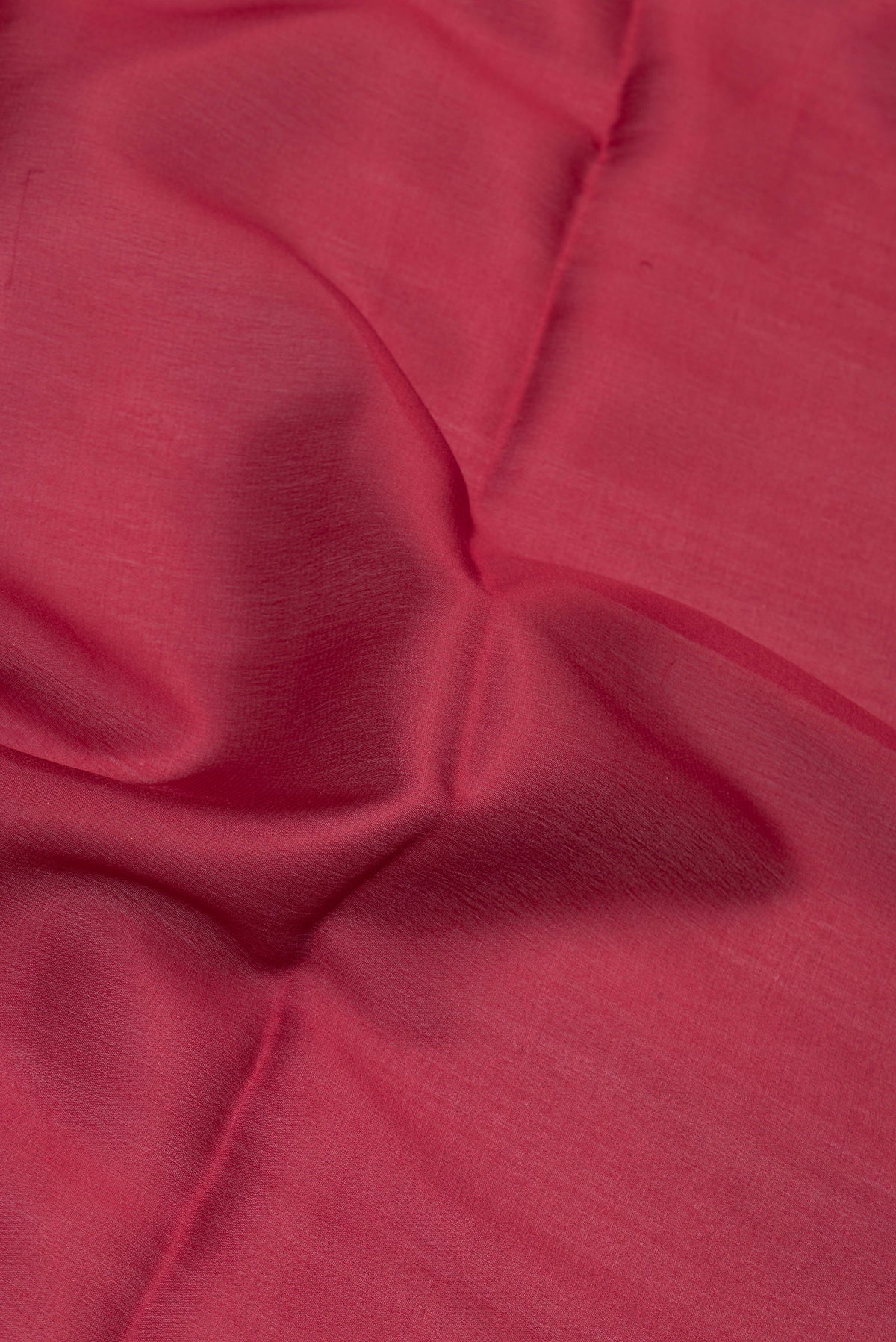 Close up of Maroon Mysore Crepe Saree with Plain Body and Zari Border.  displaying folds
