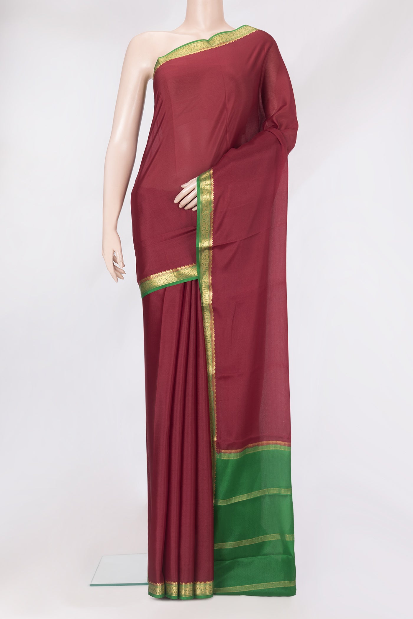 Maroon Mysore Crepe Saree with Plain Body and Zari Border.  displayed on a mannequin