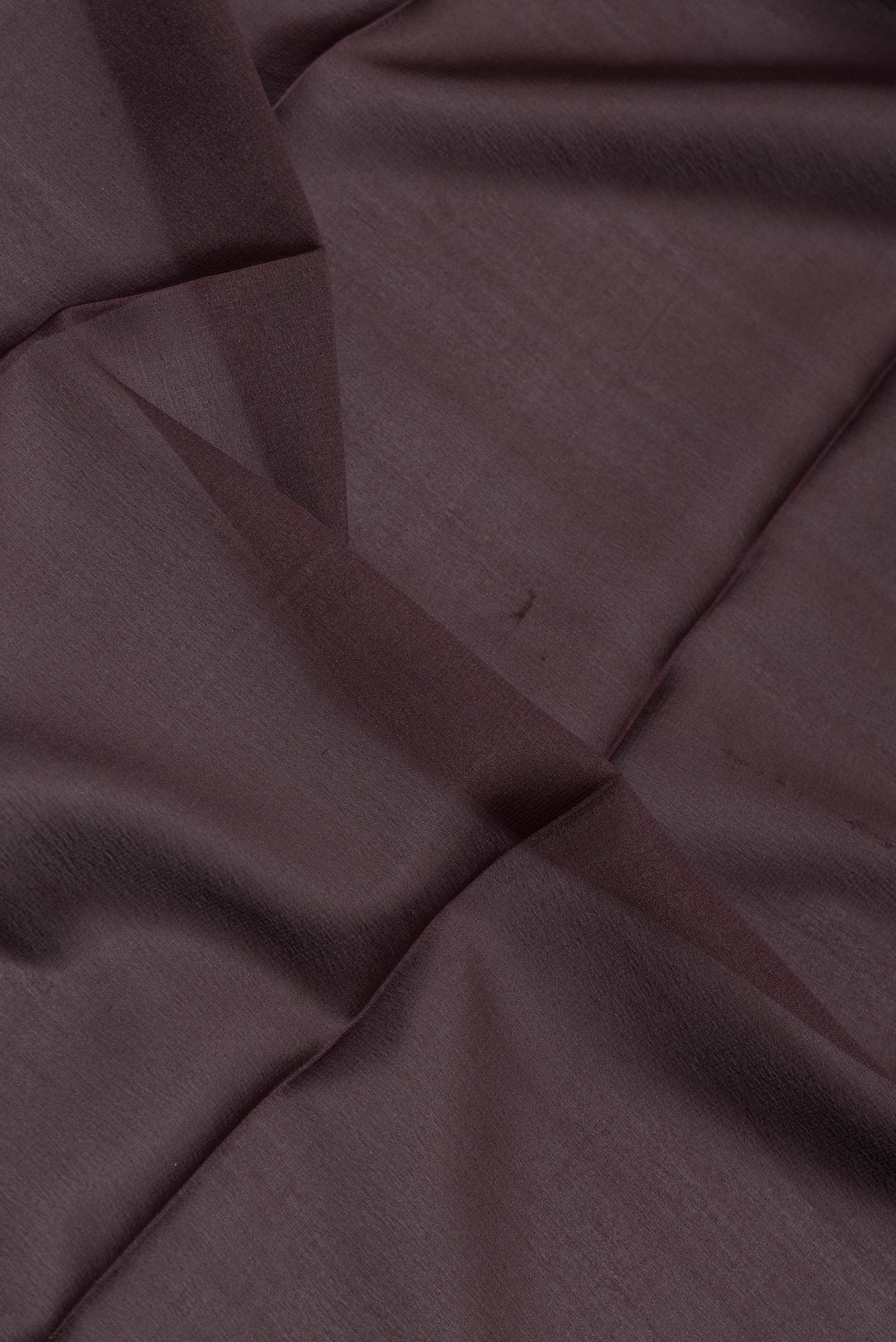 Close up of Coffee Brown Mysore Silk Saree with Plain Body and Zari Border.  displaying folds