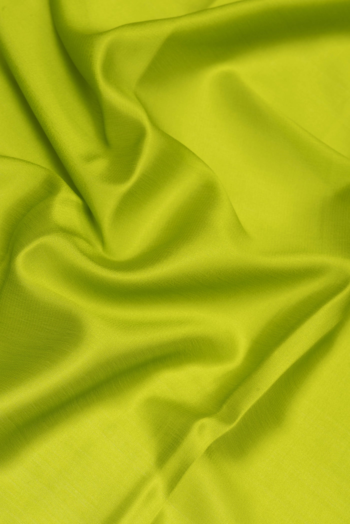 Close up of Parrot Green Mysore Silk Saree with Plain Body and Zari Border.  displaying folds