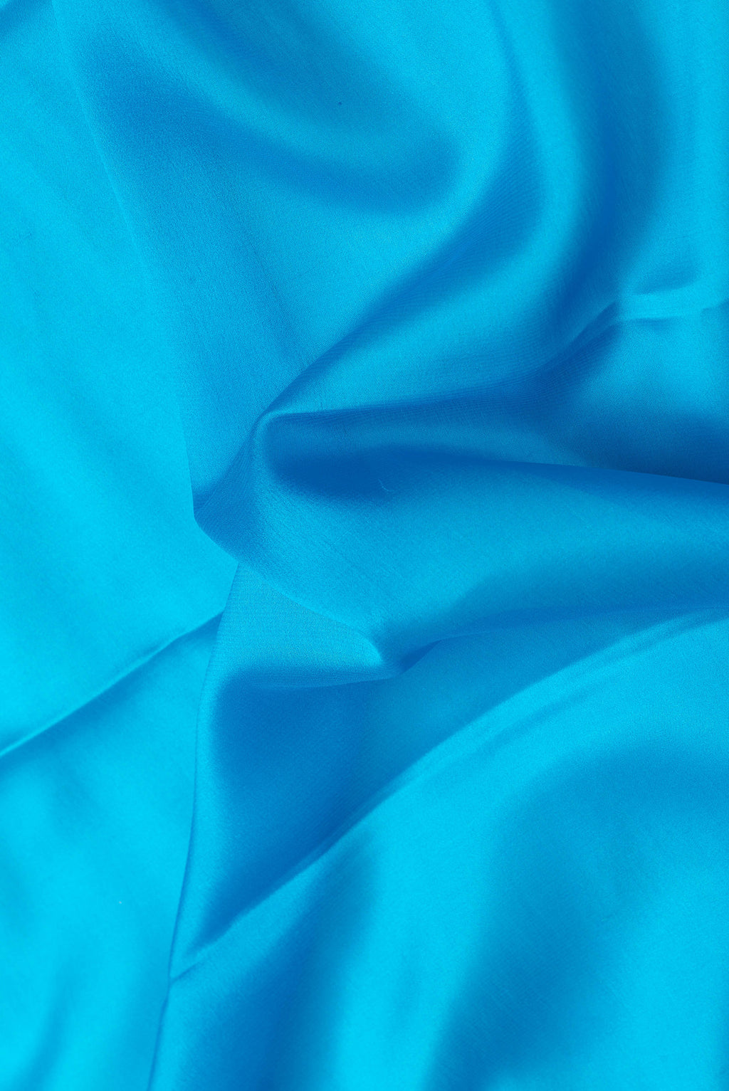 Close up of Sky Blue Dual Tone Mysore Silk Saree with Plain Body and Zari Border.  displaying folds