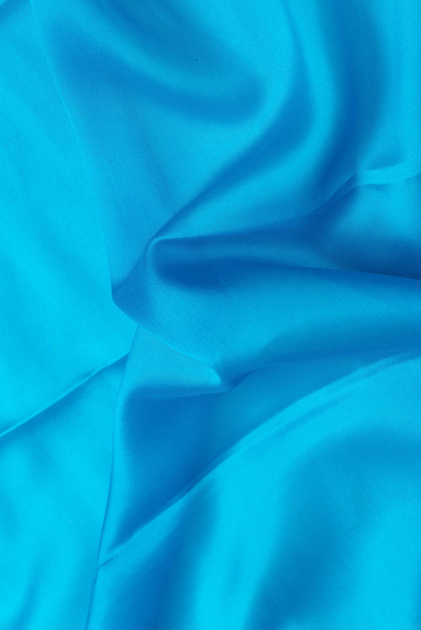 Close up of Sky Blue Dual Tone Mysore Silk Saree with Plain Body and Zari Border.  displaying folds