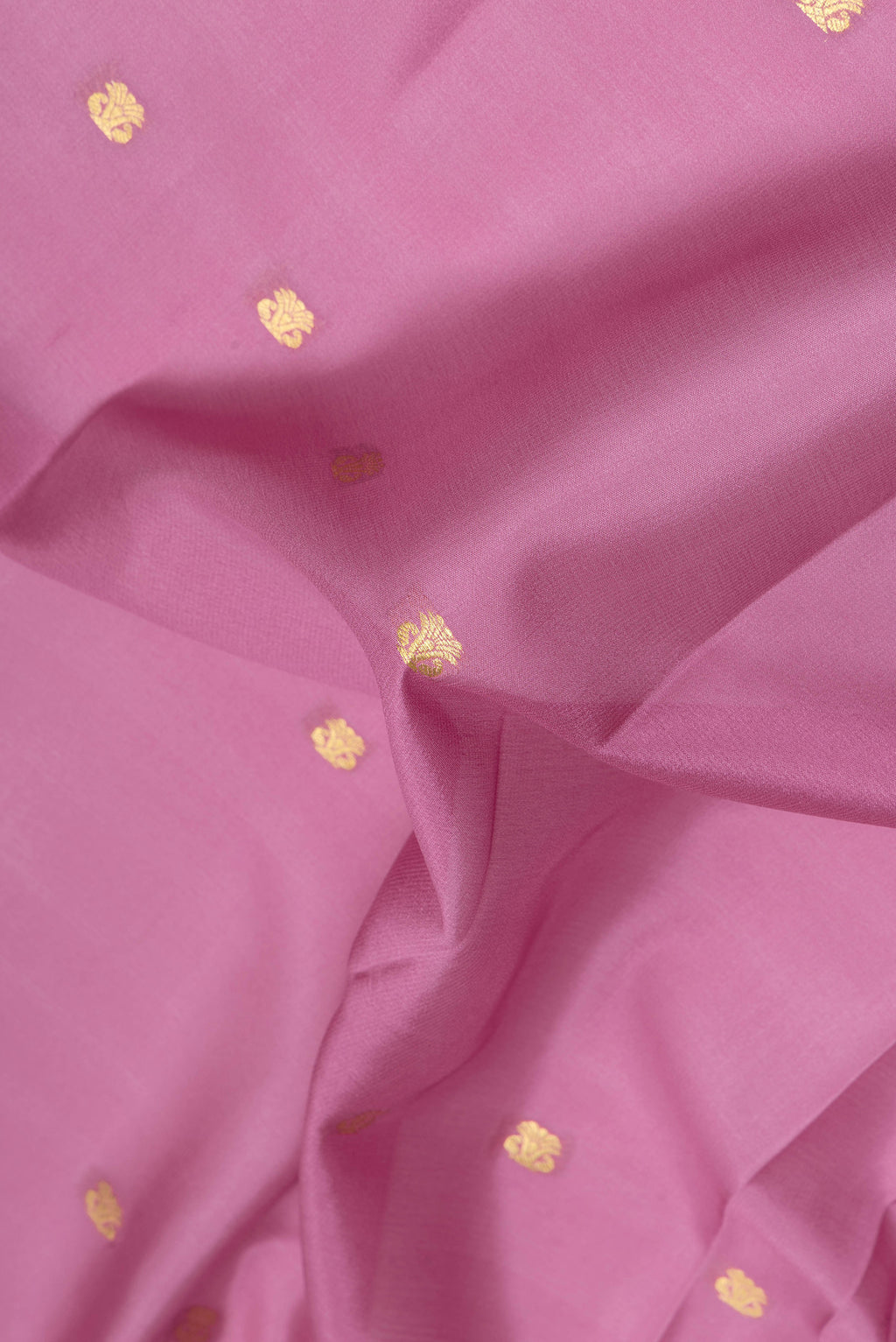 Close up of Pink Mysore Silk Saree with Zari Butta on the body and Zari Border.  displaying folds