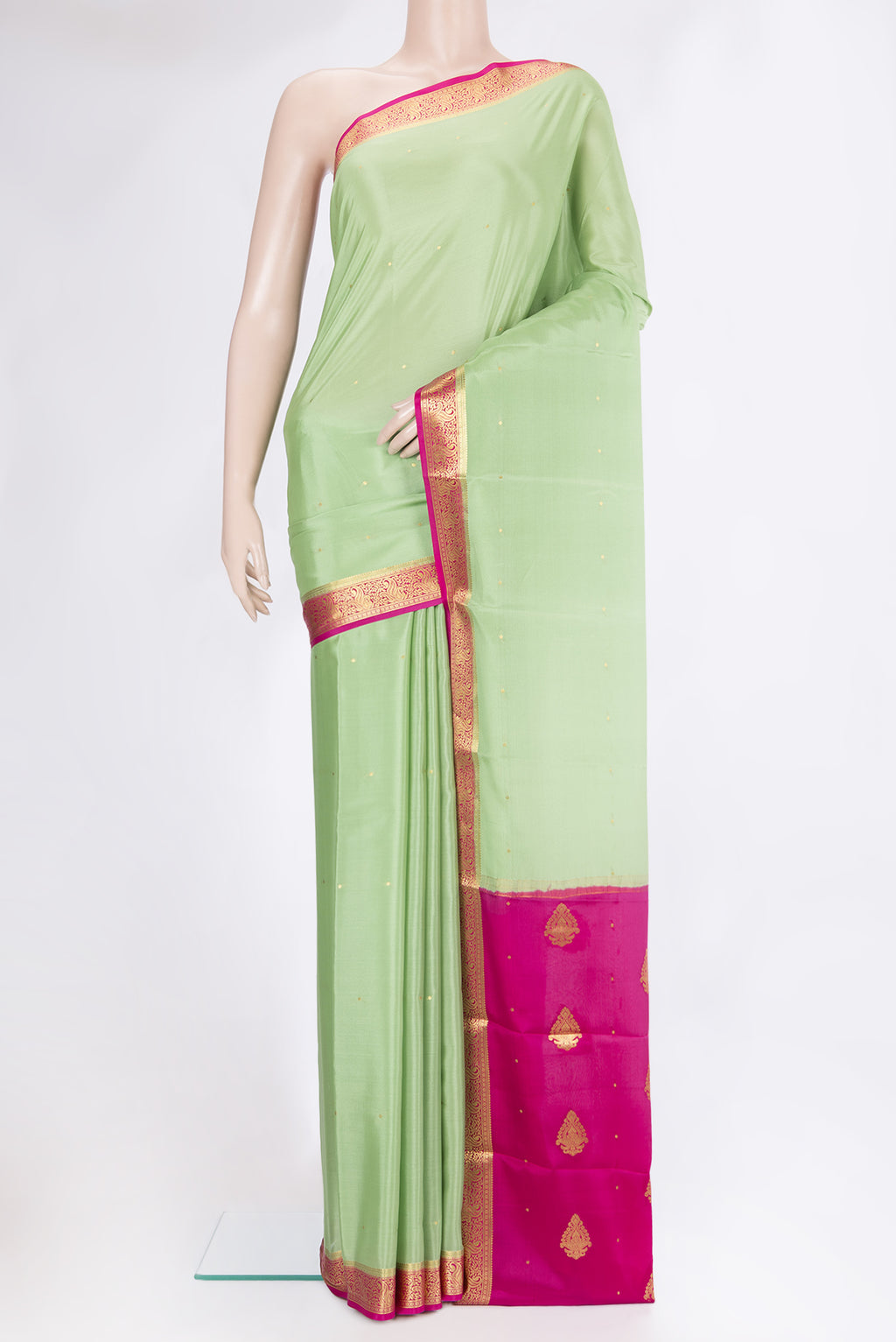 Pista Green Mysore Silk Saree with Zari Butta on the body and Zari Border.  displayed on a mannequin