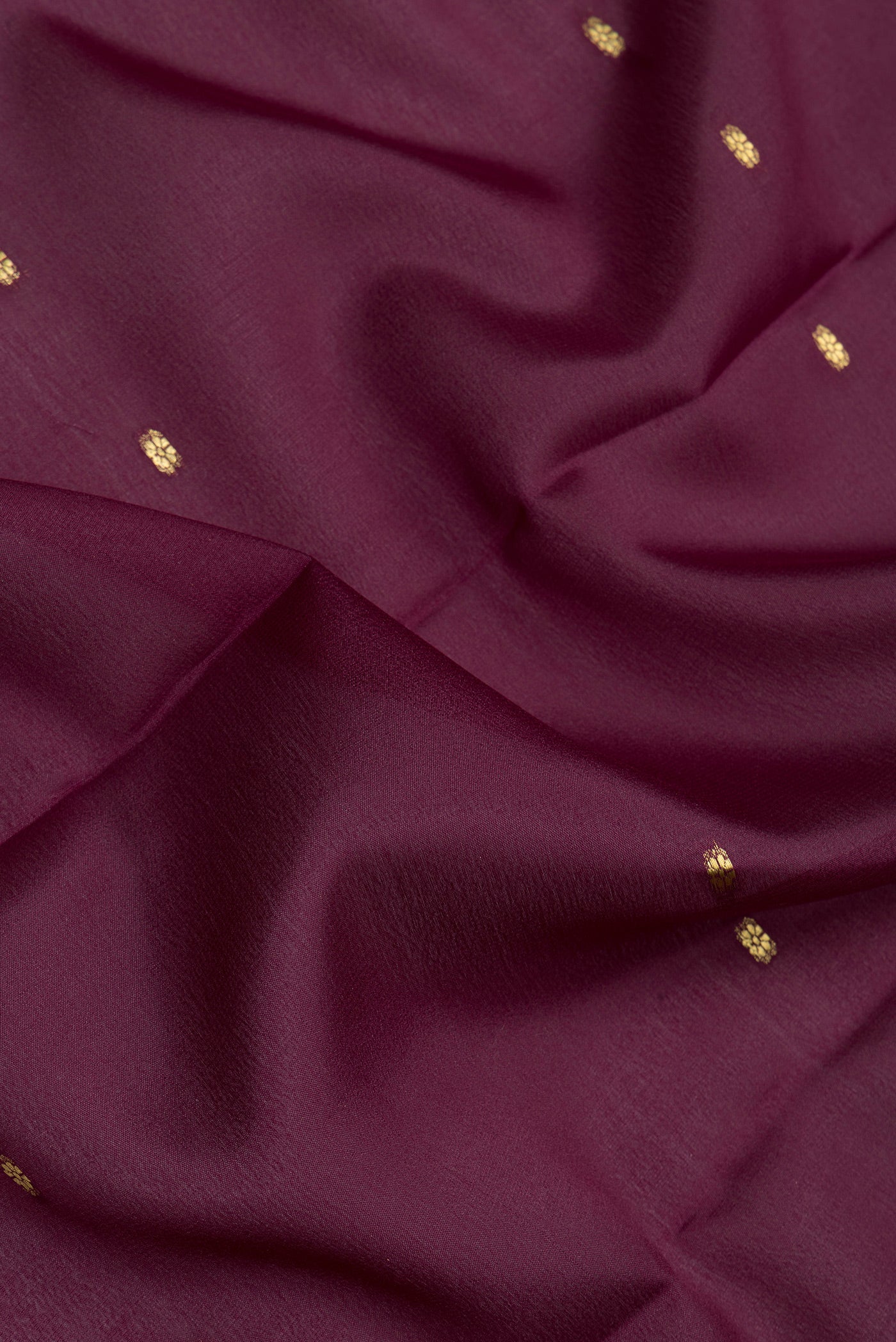 Close up of Burgundy Mysore Silk Saree with Zari Butta on the body and Zari Border.  displaying folds