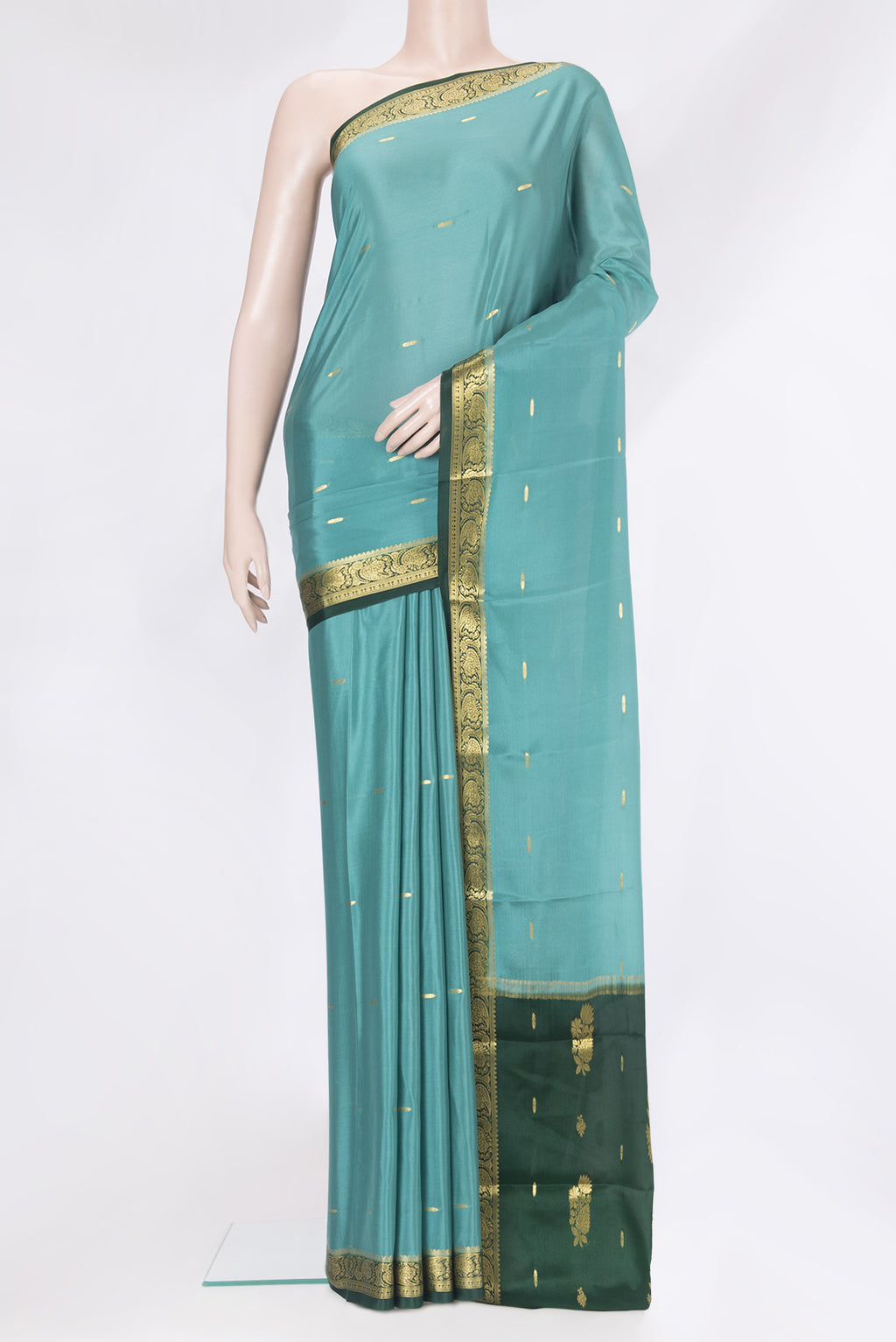 Light Green Mysore Silk Saree with Zari Butta on the body and Zari Border.  displayed on a mannequin