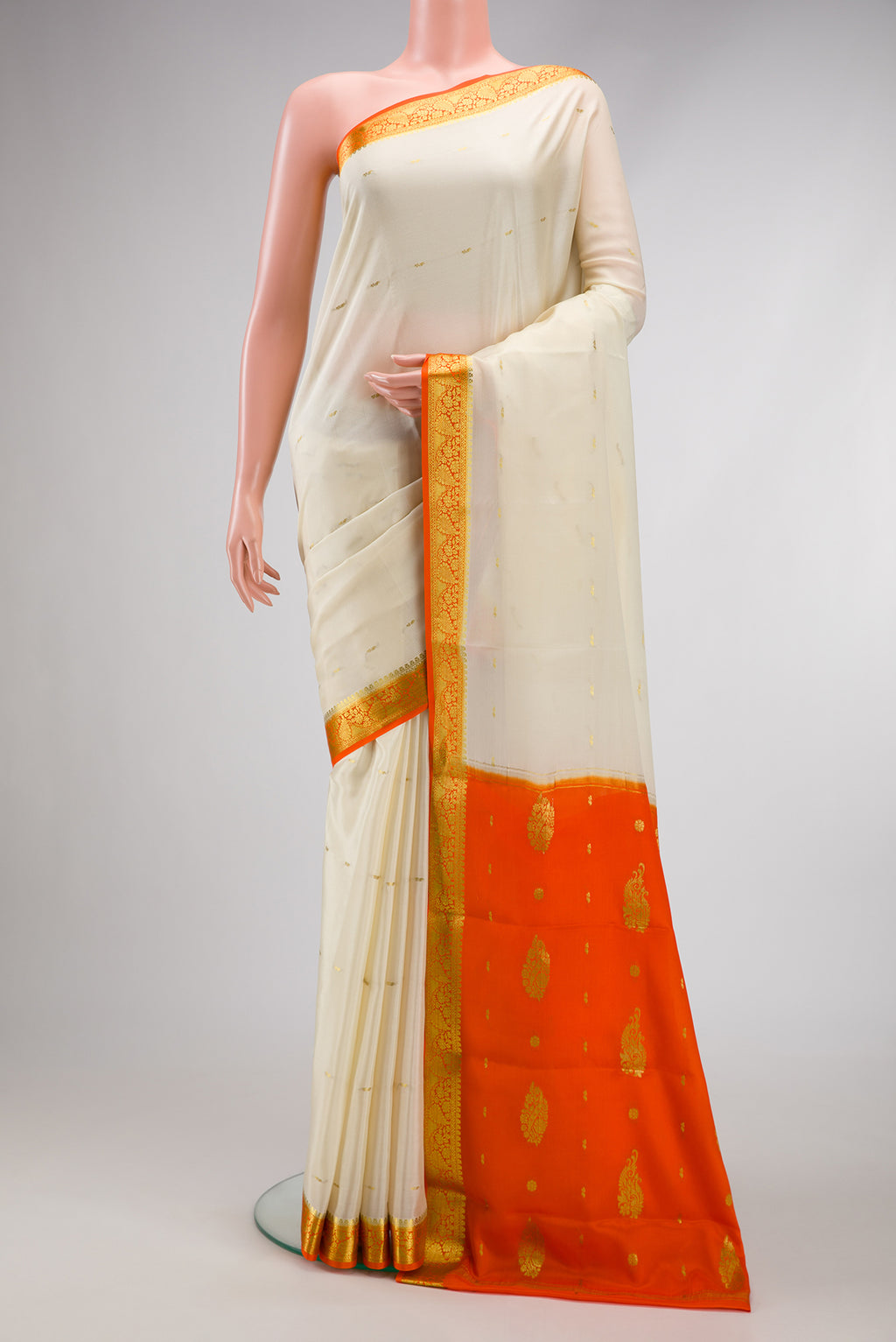 Cream Mysore Crepe Saree with Zari Butta on the body and Zari Border.  displayed on a mannequin