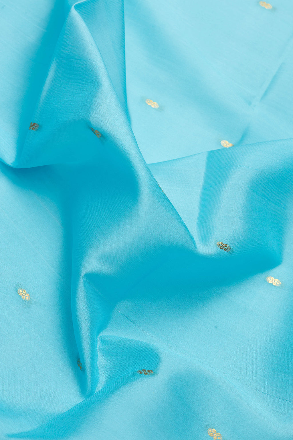 Close up of Sky Blue Dual Tone Mysore Silk Saree with Zari Butta on the body and Zari Border.  displaying folds