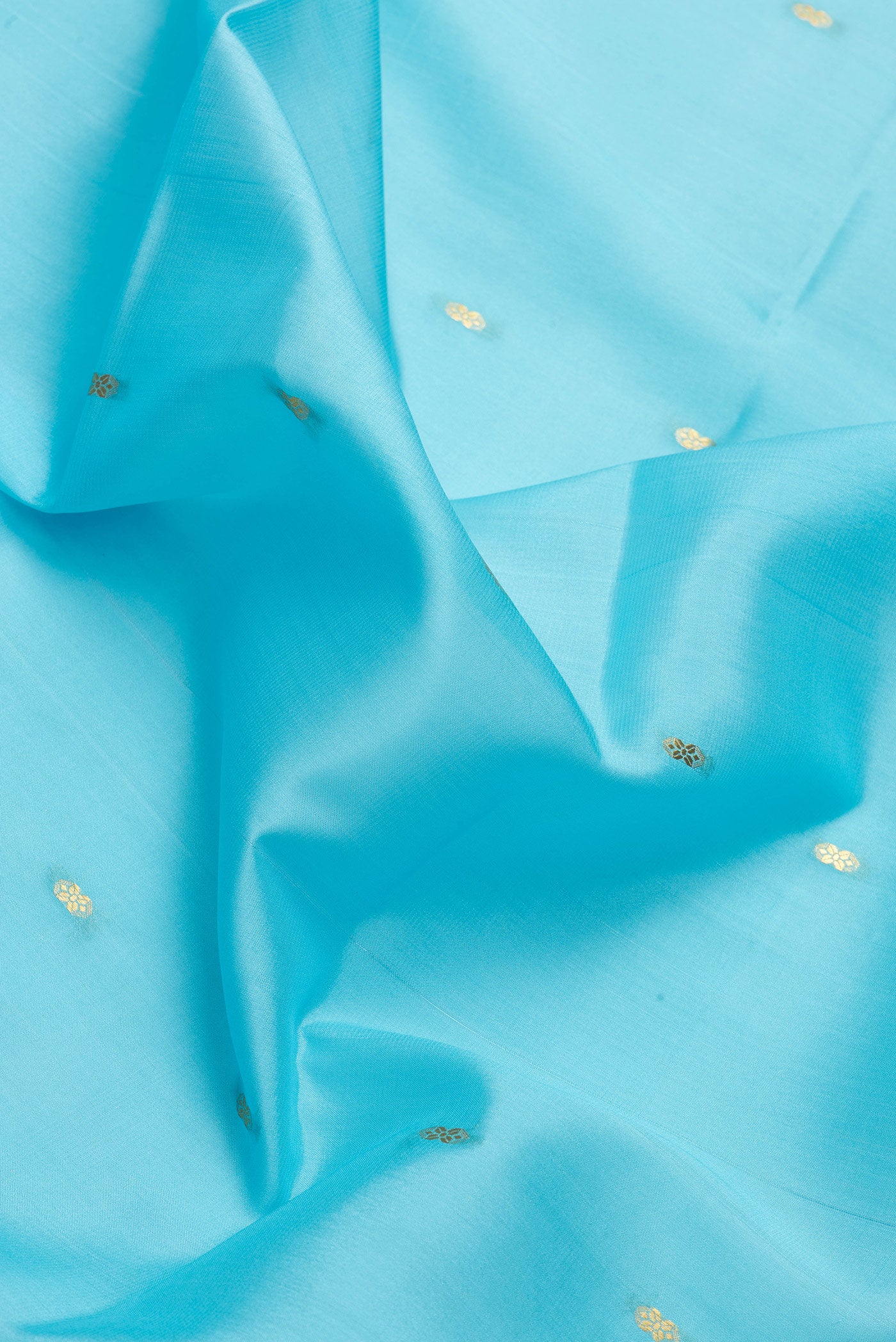 Close up of Sky Blue Dual Tone Mysore Silk Saree with Zari Butta on the body and Zari Border.  displaying folds