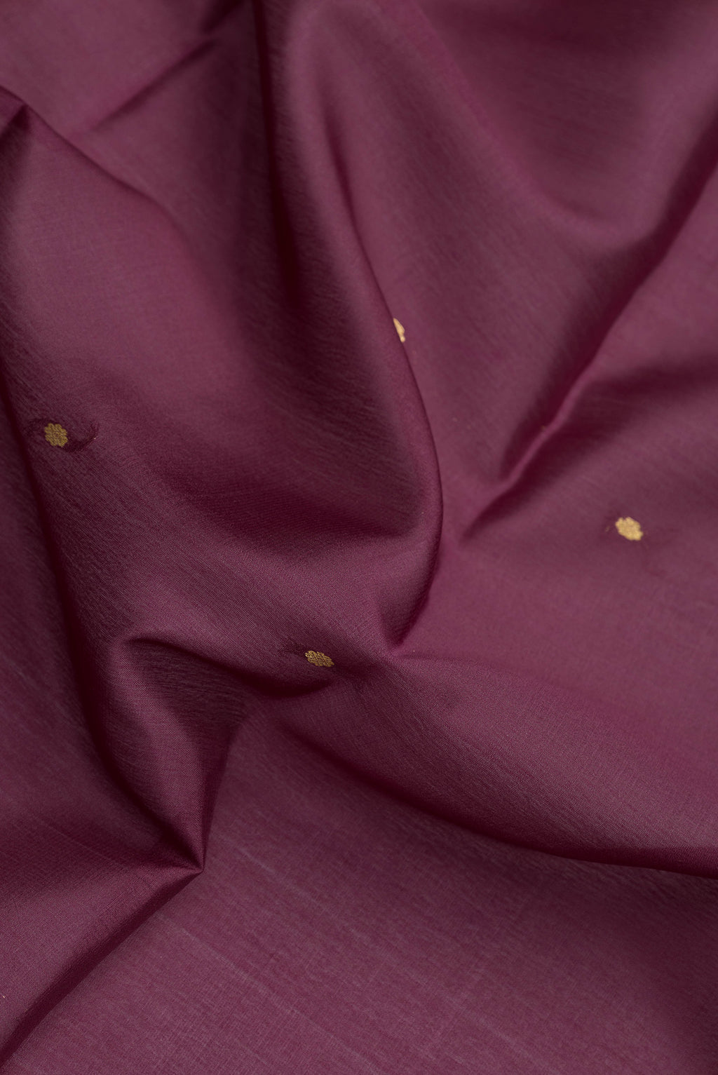 Close up of Burgundy Dual Tone Mysore Silk Saree with Zari Butta on the body and Zari Border.  displaying folds
