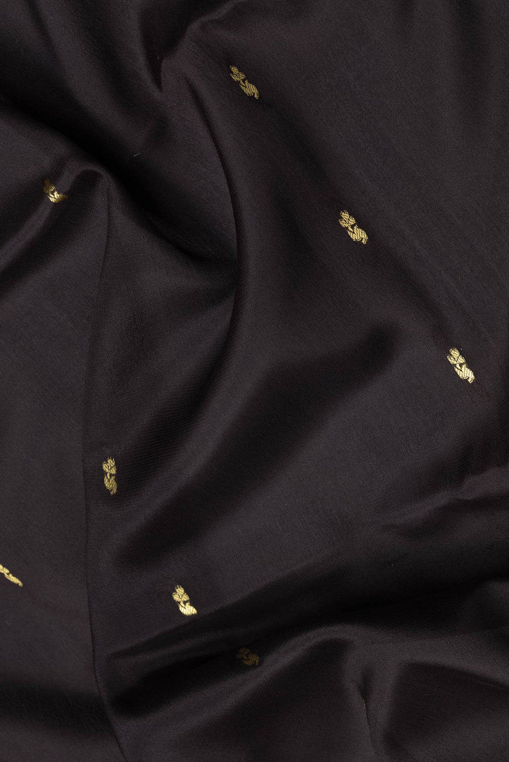 Close up of Black Dual Tone Mysore Silk Saree with Zari Butta on the body and Zari Border.  displaying folds