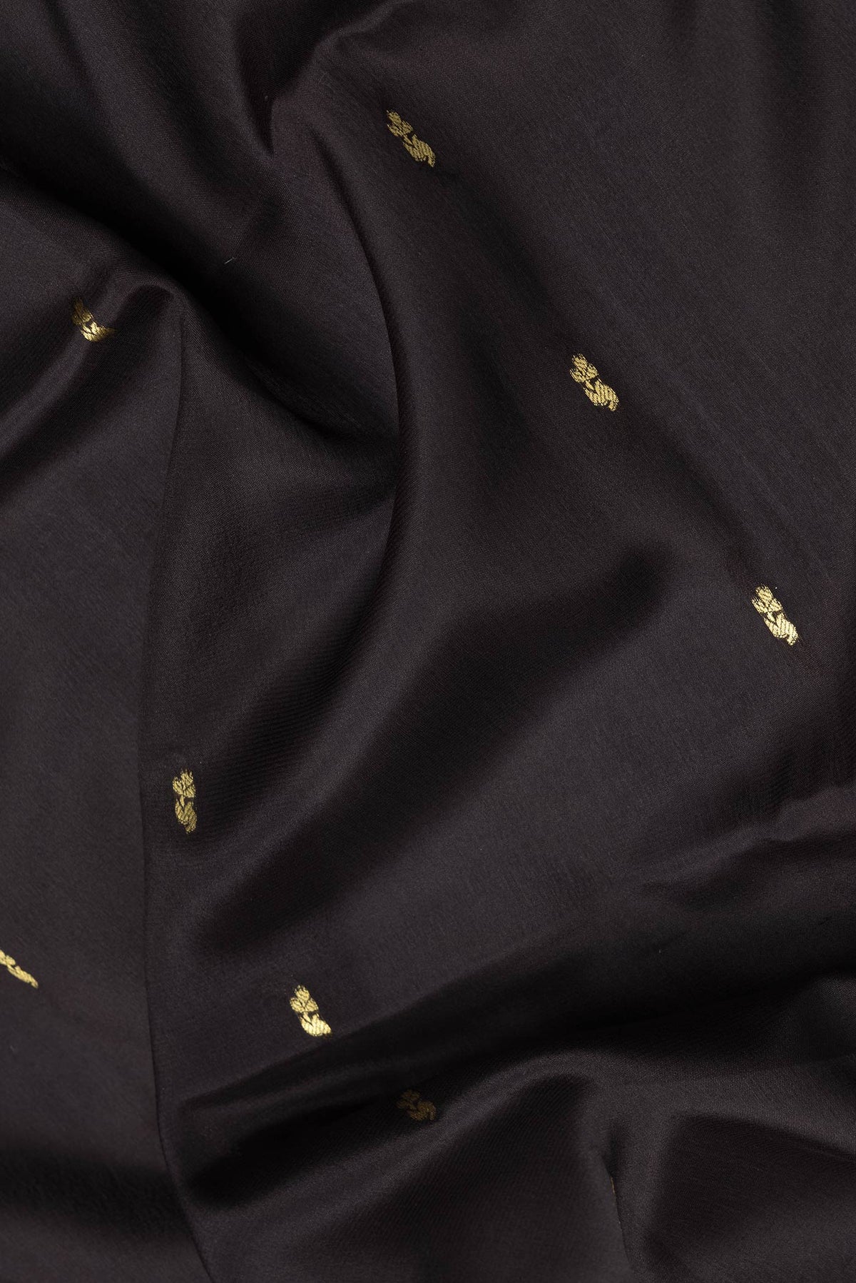 Close up of Black Dual Tone Mysore Silk Saree with Zari Butta on the body and Zari Border.  displaying folds