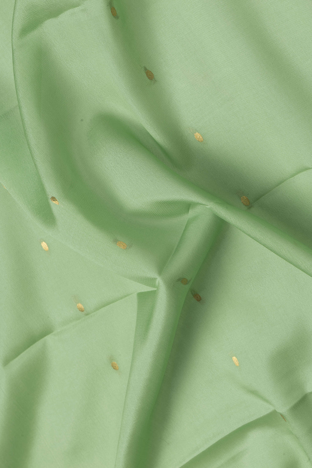 Close up of Pista Green Dual Tone Mysore Silk Saree with Zari Butta on the body and Zari Border.  displaying folds