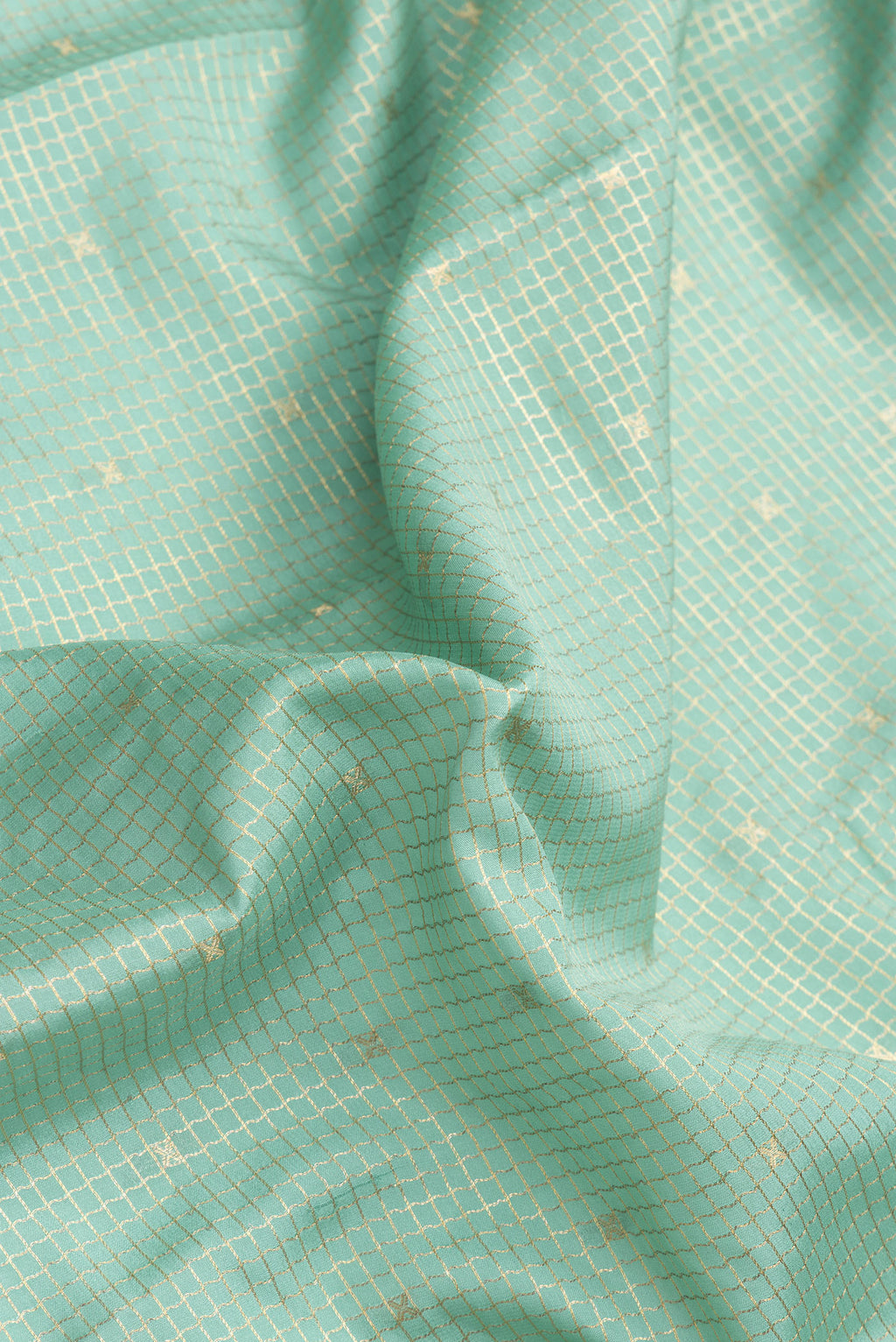 Close up of Light Green Dual Tone Mysore Silk Saree with Checked design on the body and Zari Border.  displaying folds