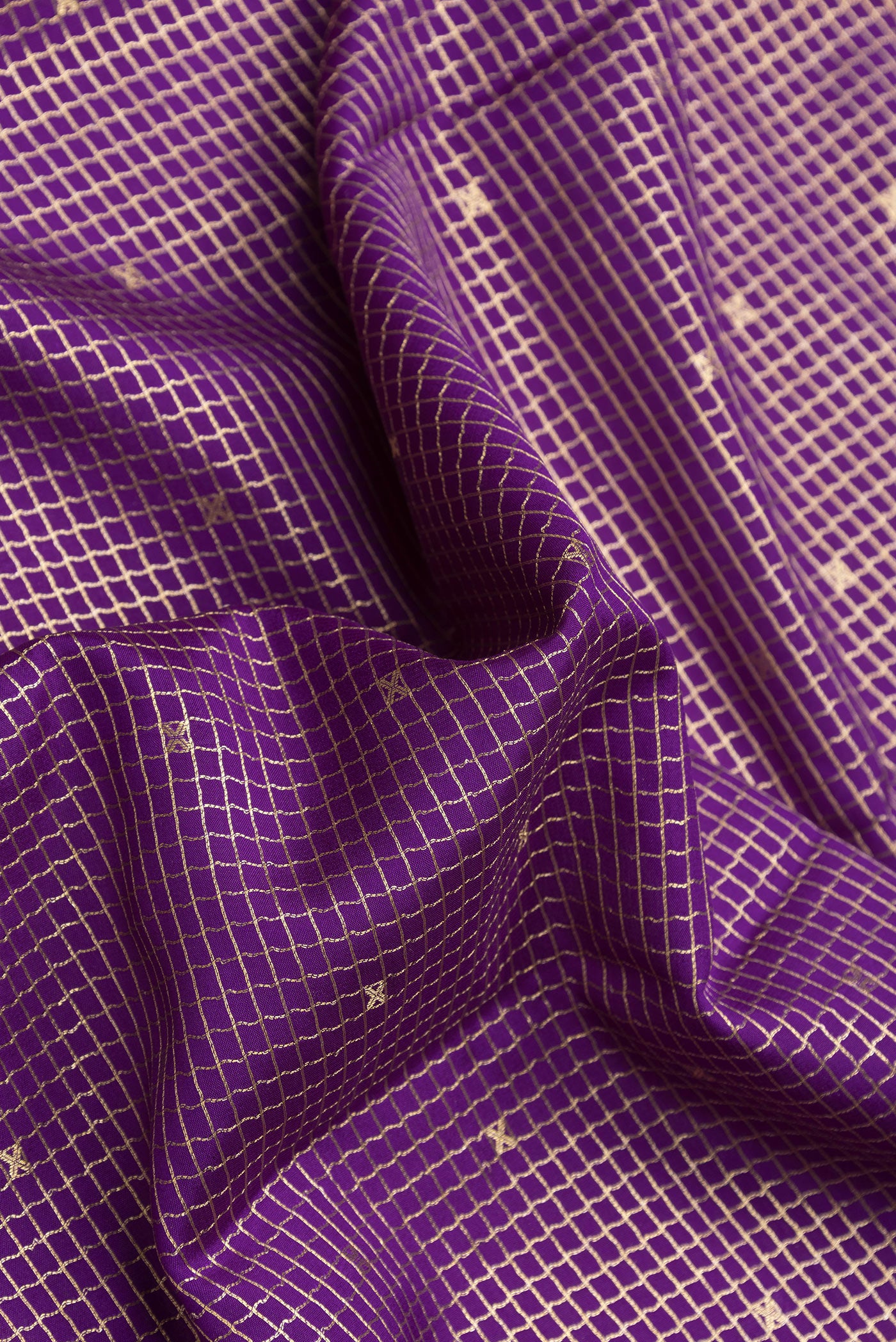 Close up of Violet Dual Tone Mysore Silk Saree with Checked design on the body and Zari Border.  displaying folds