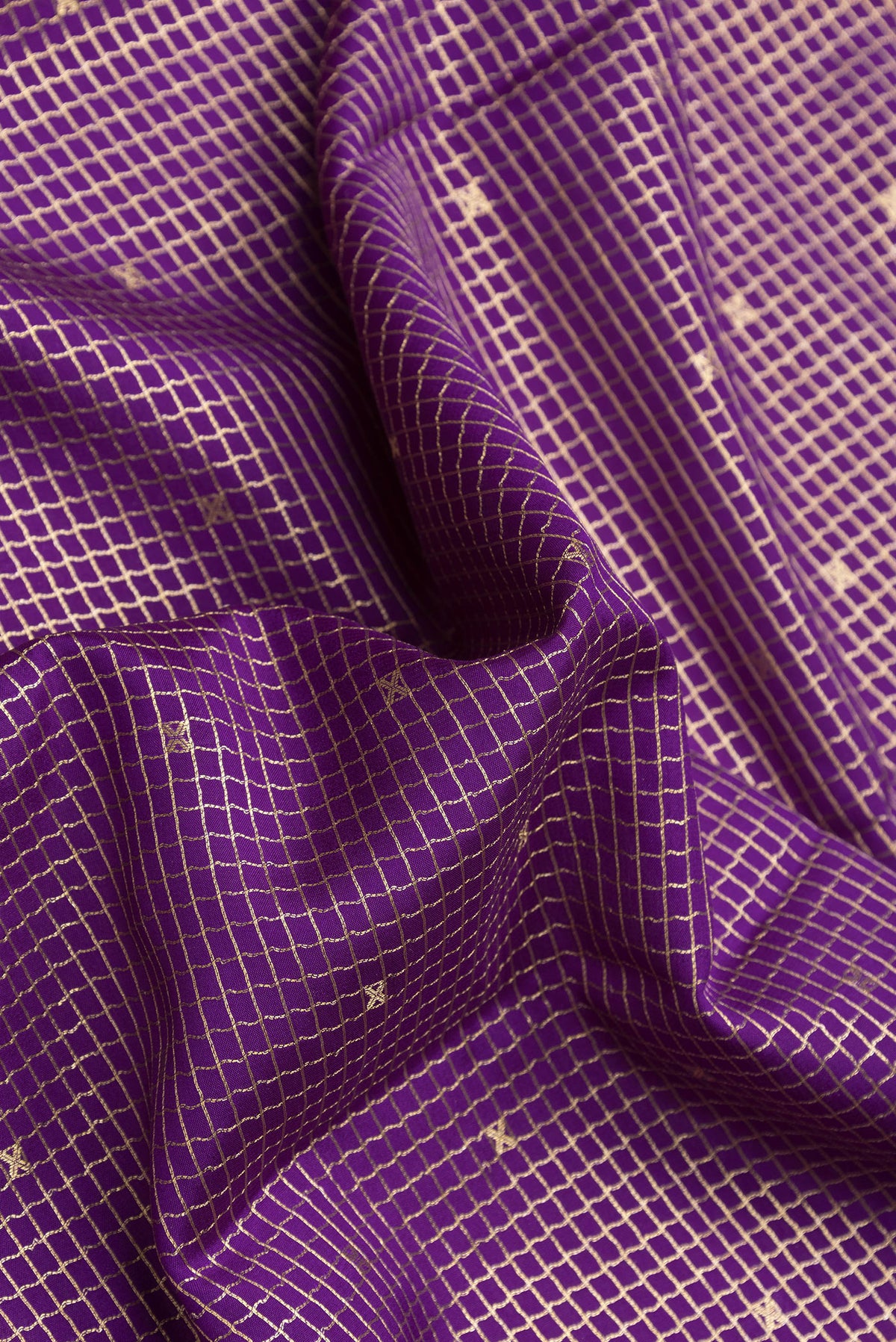 Close up of Violet Dual Tone Mysore Silk Saree with Checked design on the body and Zari Border.  displaying folds