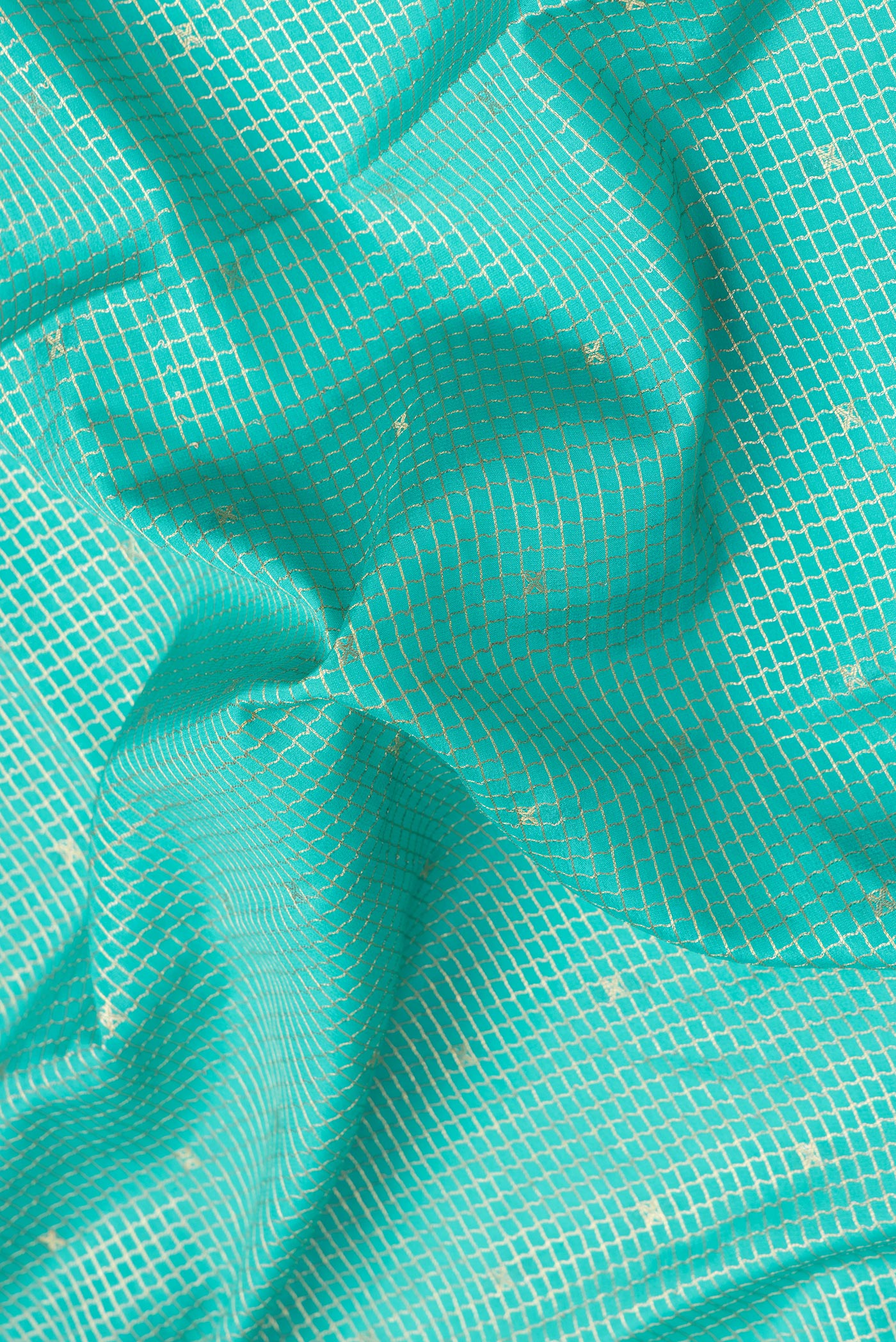 Close up of Sea Green Mysore Crepe Saree with Checked design on the body and Zari Border.  displaying folds