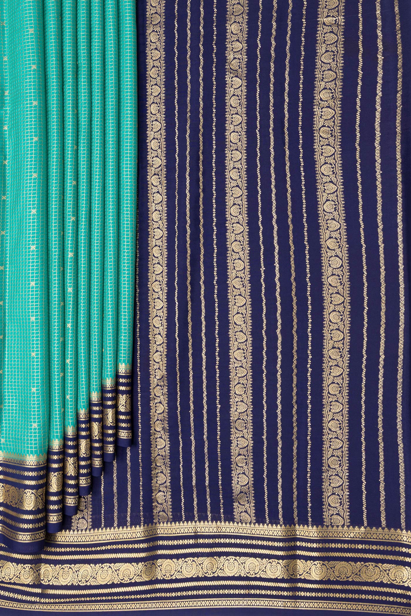 Pleats and pallu of Sea Green Mysore Crepe Saree with Checked design on the body and Zari Border. 