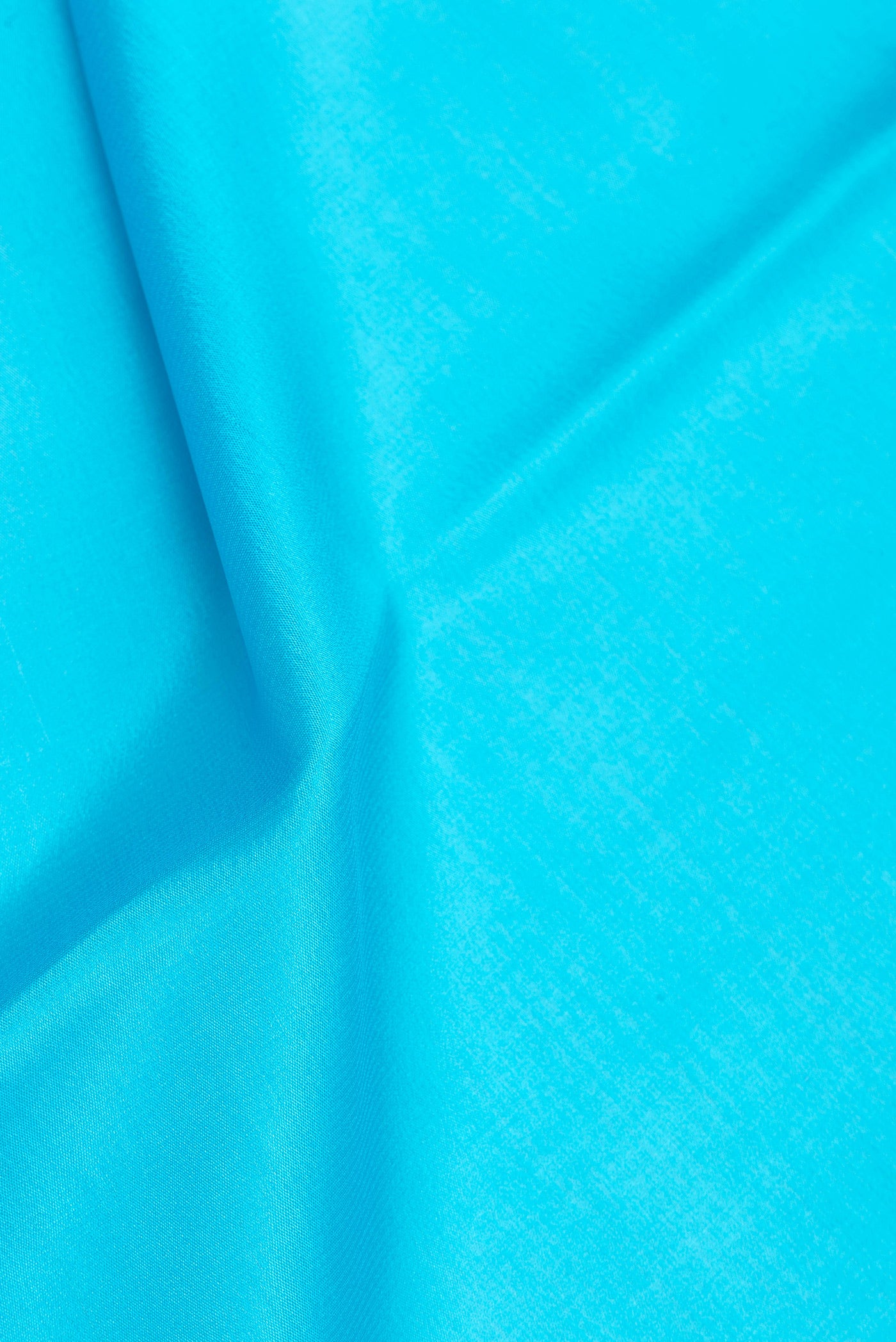 Close up of Sky Blue Mysore Silk Saree with Plain Body and Zari Border.  displaying folds