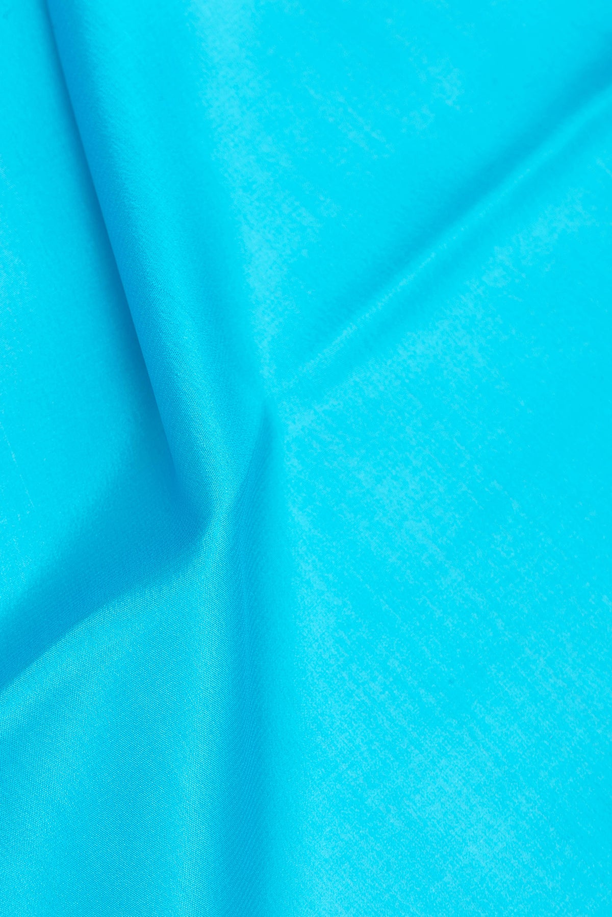 Close up of Sky Blue Mysore Silk Saree with Plain Body and Zari Border.  displaying folds