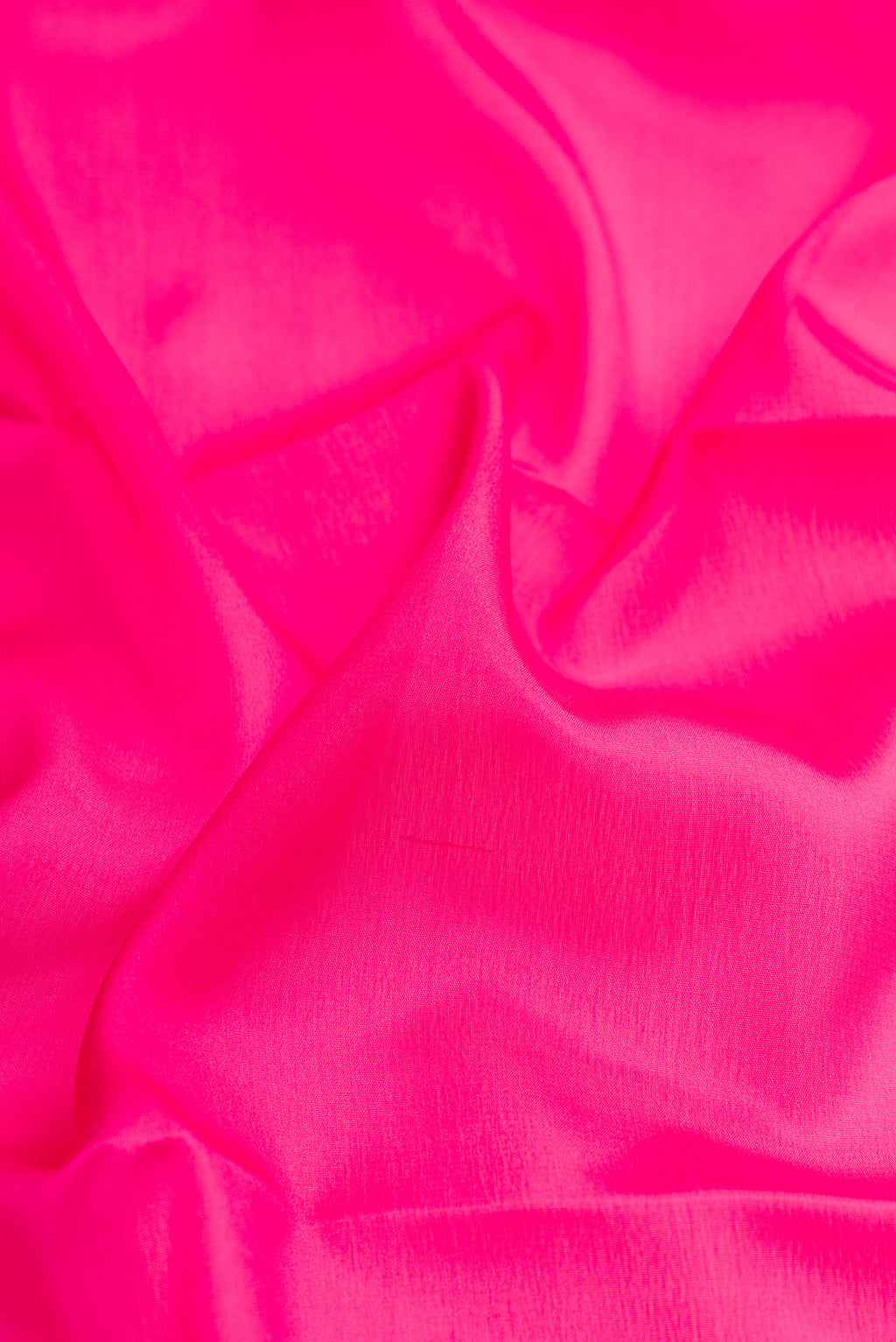Close up of Pink Mysore Crepe Saree with Plain Body and Zari Border.  displaying folds