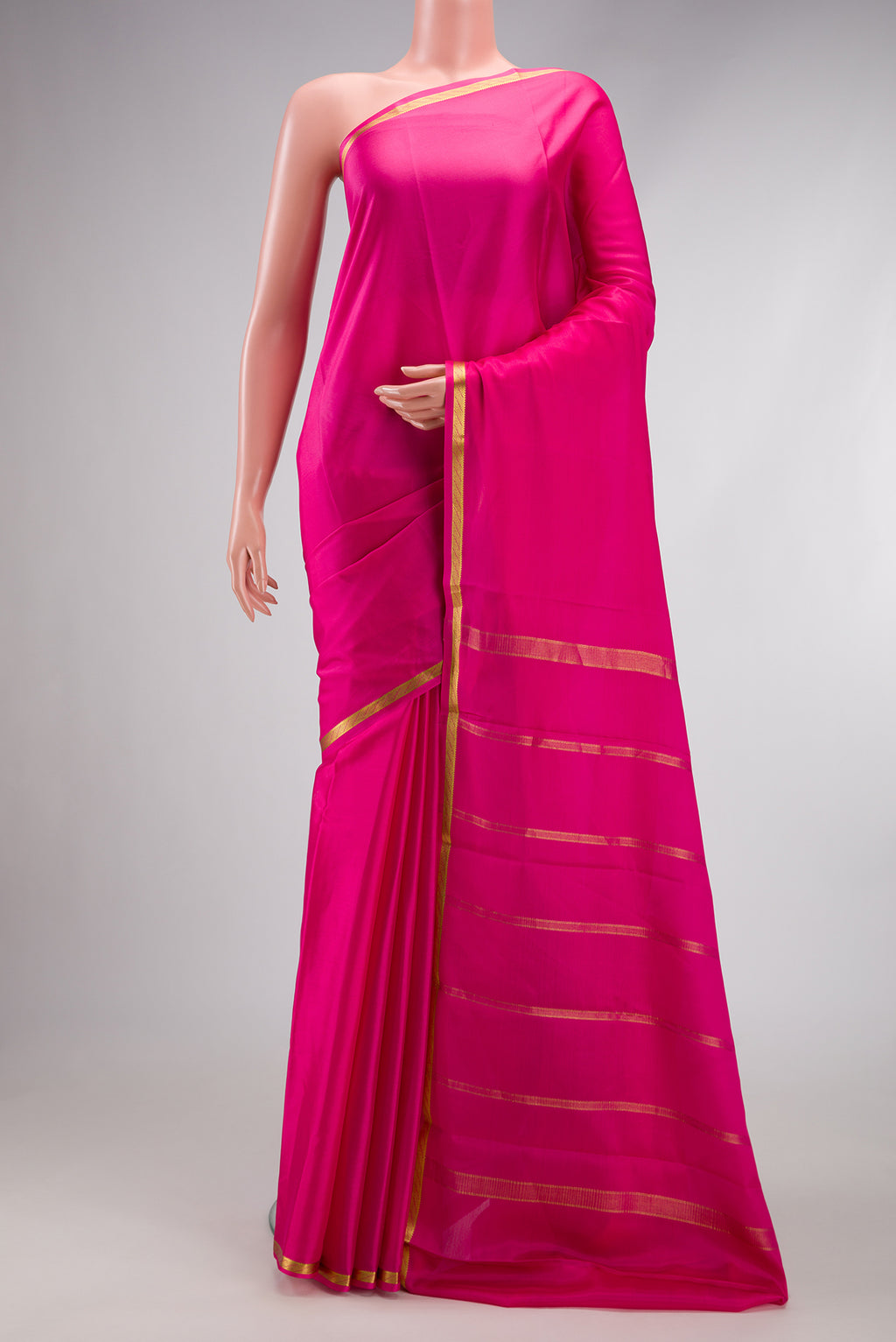 Pink Mysore Crepe Saree with Plain Body and Zari Border.  displayed on a mannequin