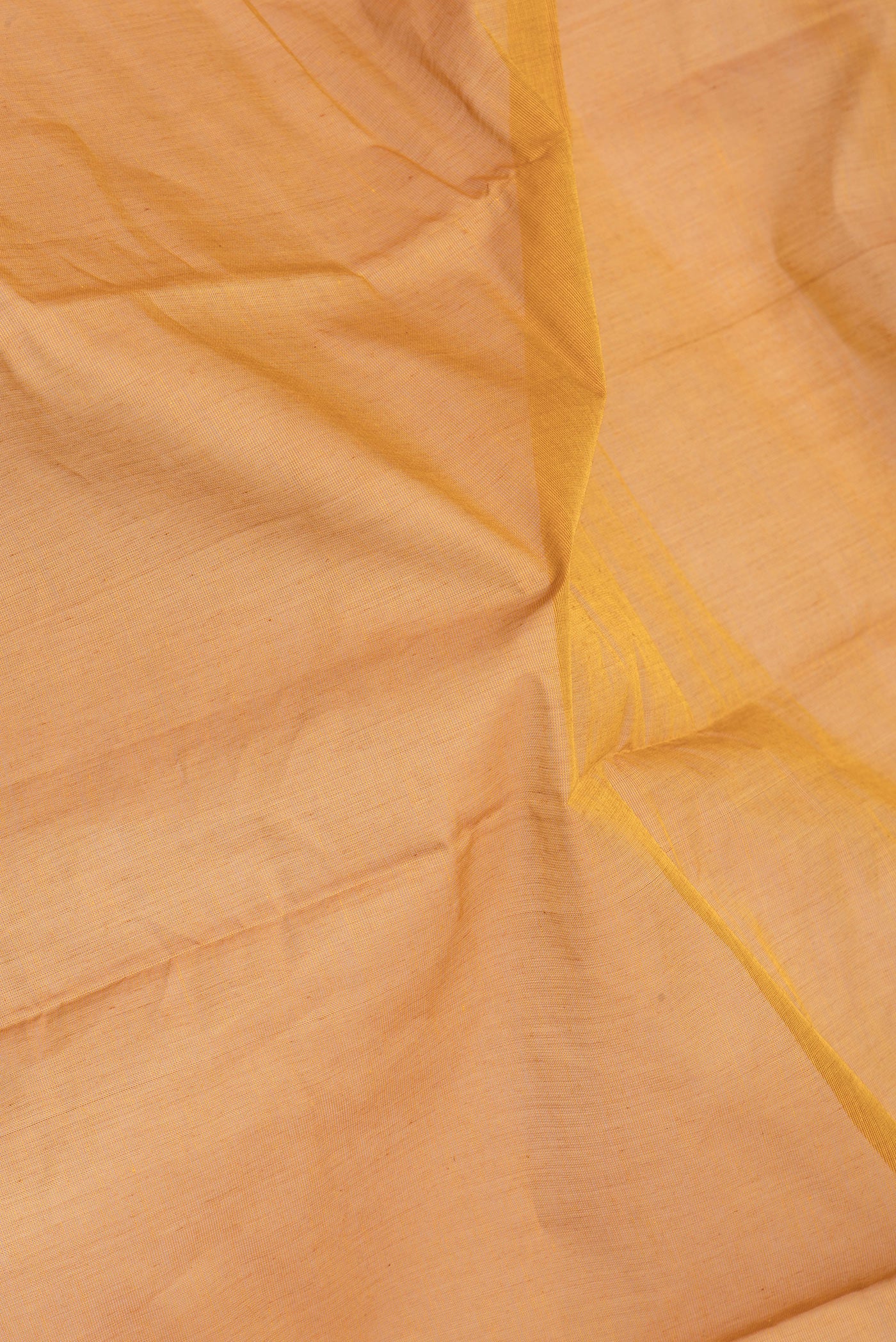 Close up of Mustard Kanchi Cotton Saree with Plain Body and Temple Border.  displaying folds