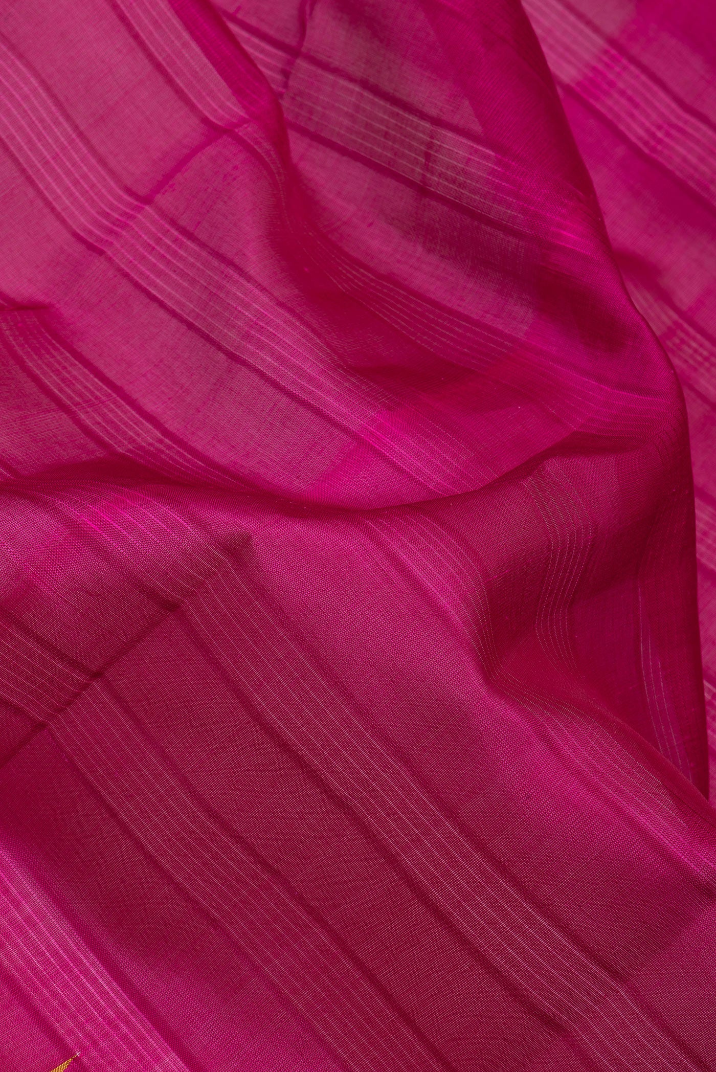 Close up of Magenta Kanchi Cotton Saree with Stripes on the body and Temple Border.  displaying folds