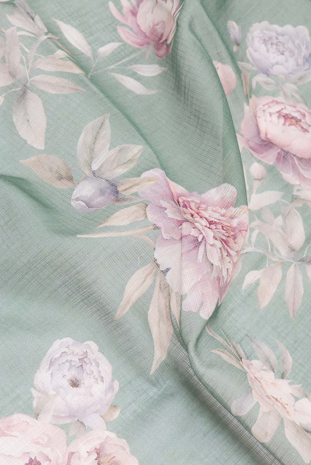 Close up of Green Kota Silk Saree with Printed design on the body and Thread Border.  displaying folds
