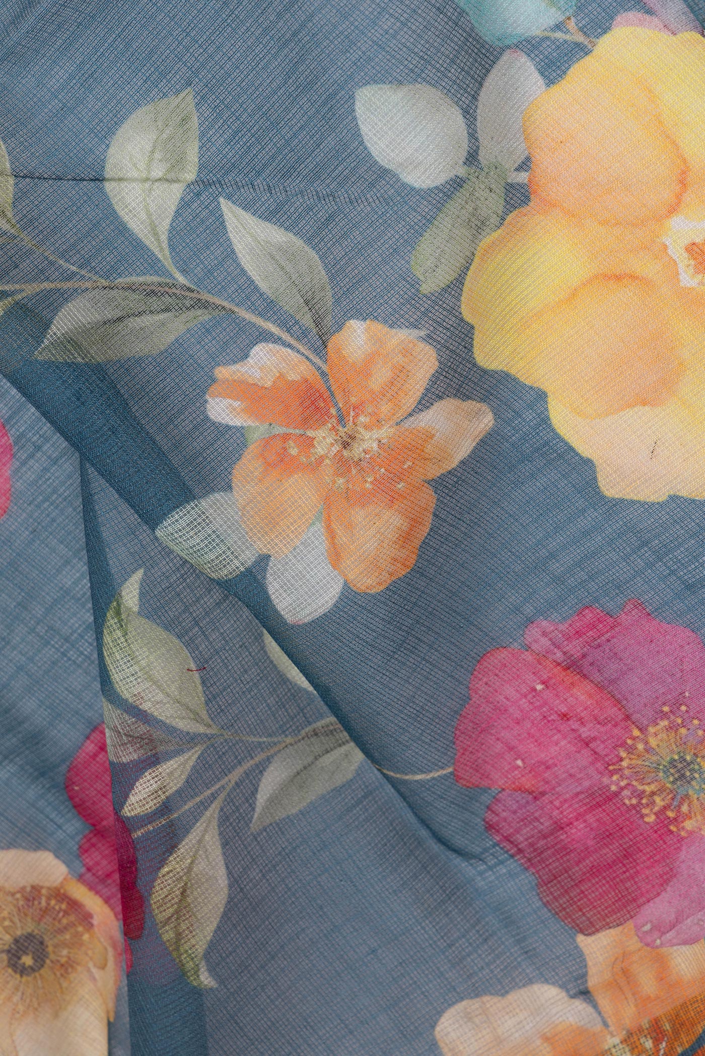 Close up of Grey Kota Silk Saree with Floral Print on the body and Thread Border.  displaying folds
