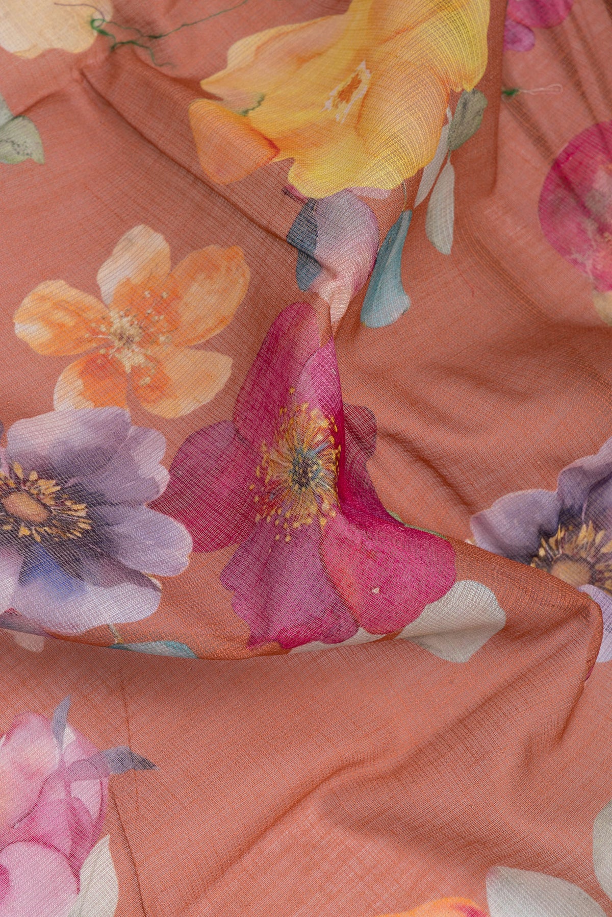 Close up of Brown Kota Silk Saree with Floral Print on the body and Thread Border.  displaying folds