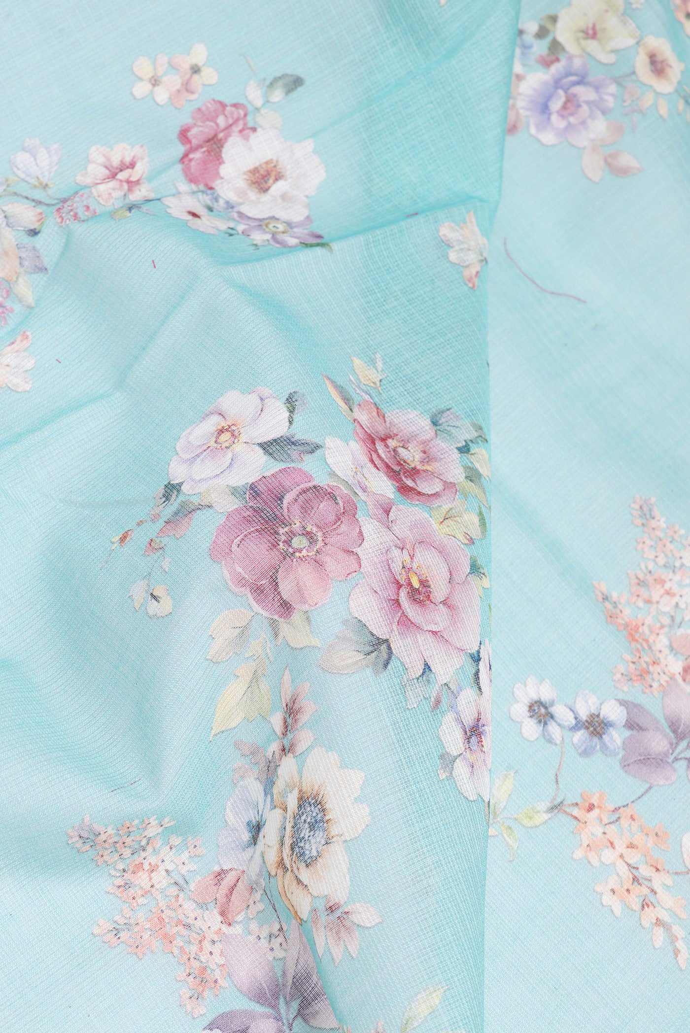 Close up of Sky Blue Kota Silk Saree with Floral Print on the body and Thread Border.  displaying folds