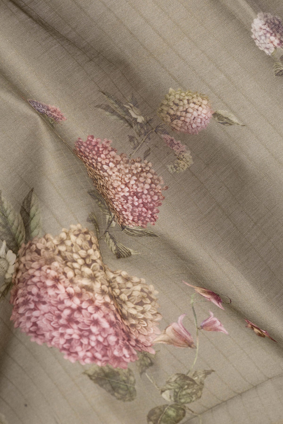 Close up of Mehandi Green Dual Tone Chanderi Silk Cotton Saree with Printed design on the body and Zari And Thread Border.  displaying folds