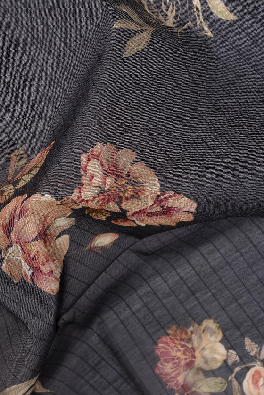 Close up of Pure Silk Black Dual Tone Chanderi Saree with Printed design on the body and Zari And Thread Border.  displaying folds