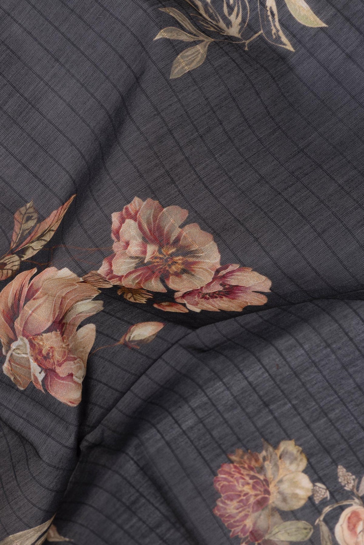 Close up of Pure Silk Black Dual Tone Chanderi Saree with Printed design on the body and Zari And Thread Border.  displaying folds